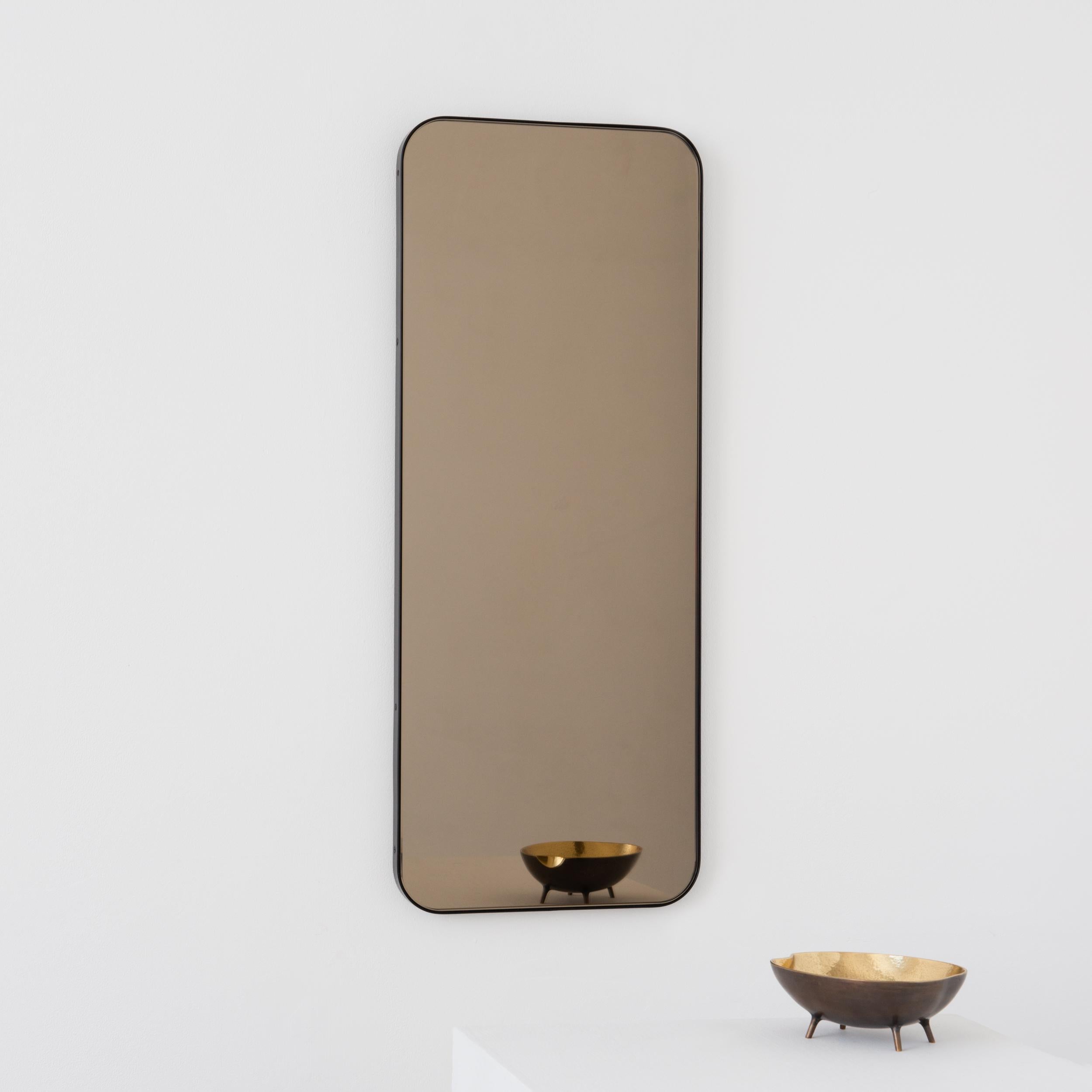 The images in this bespoke listing do not represent the approved modifications, and they refer to a standard size of the Quadris Rectangular Bronze Tinted Mirror with Bronze Patina Brass Frame. All specifications for this particular listing are as