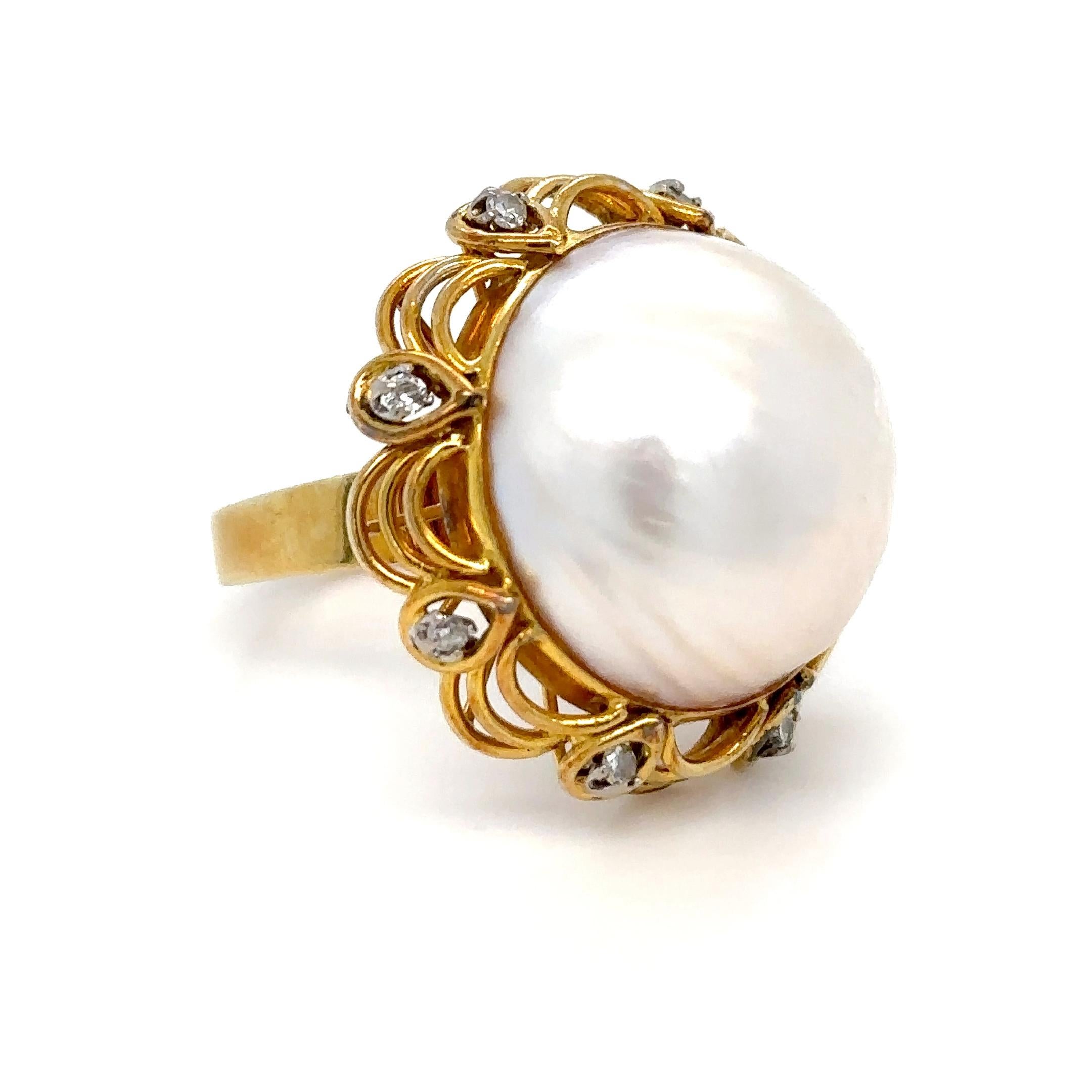 A Bespoke Round Mabé Pearl Cluster Ring, set in 14ct yellow gold within a border of 8 round brilliant cut diamonds on wire festooning on a 4.5 to 3.0mm tapered flat band.

Mabé pearl 20mm

Diamonds 8 = 0.20ct (estimated), G to H/SI

Metal: 14ct