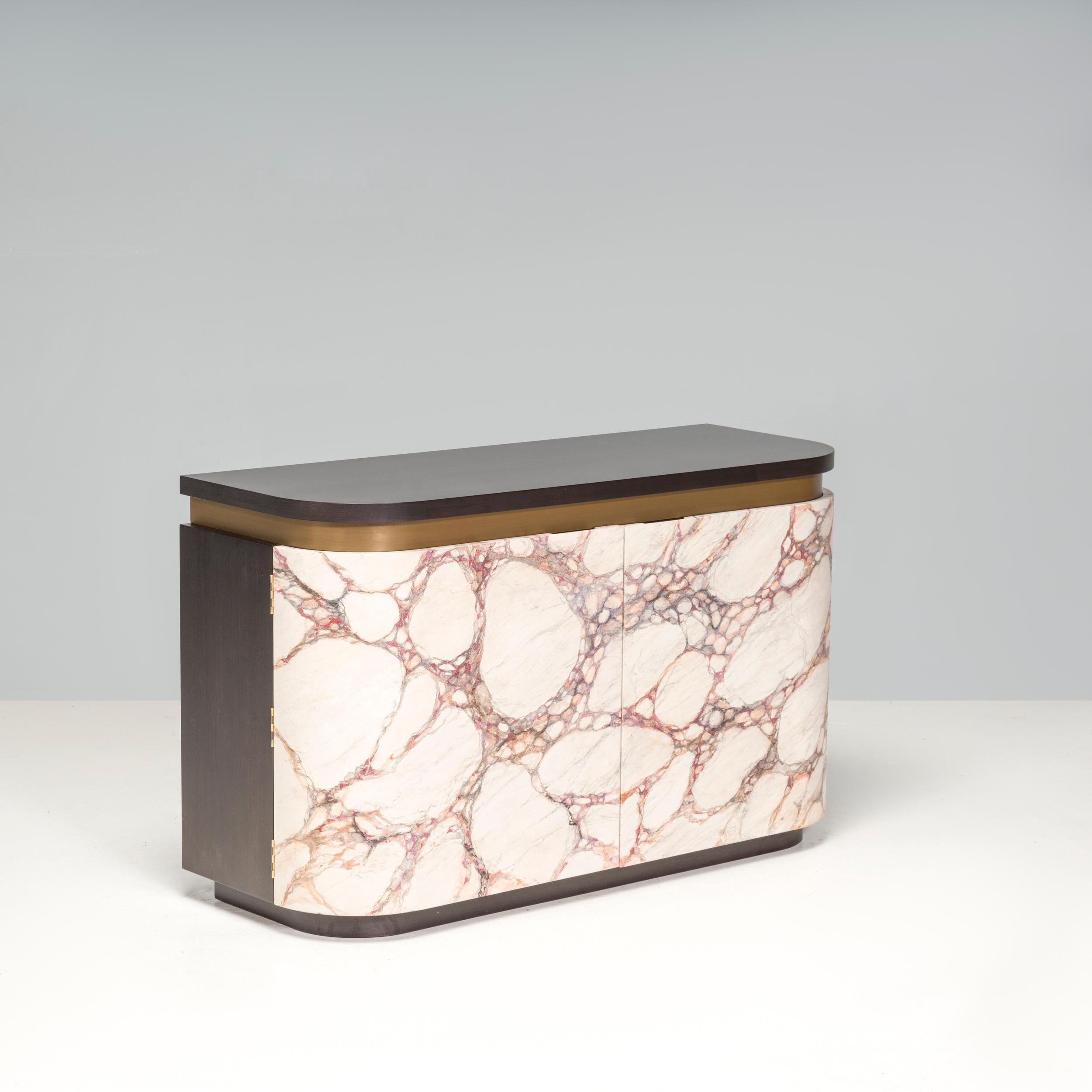 The Bespoke Marble Effect Side Board is a sleek, modern design with a mix of materials. The dark wooden panelling contrasts beautifully with the lighter and brighter colours of the marbling. When opened, the doors reveal spacious shelves also backed