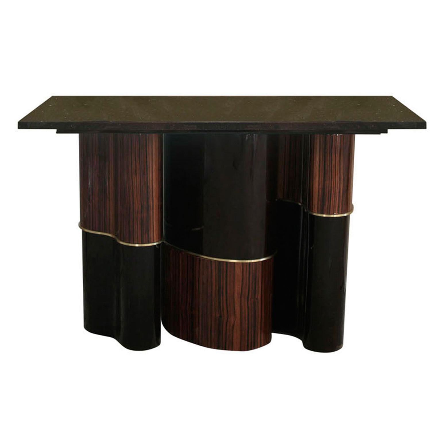 Modern console with three part curved pedestal base crafted in Macassar, brass and black lacquer, finished off in a high gloss. Custom materials and finishes upon request including sizes. Tops available in black or white marble or granite. 
Please