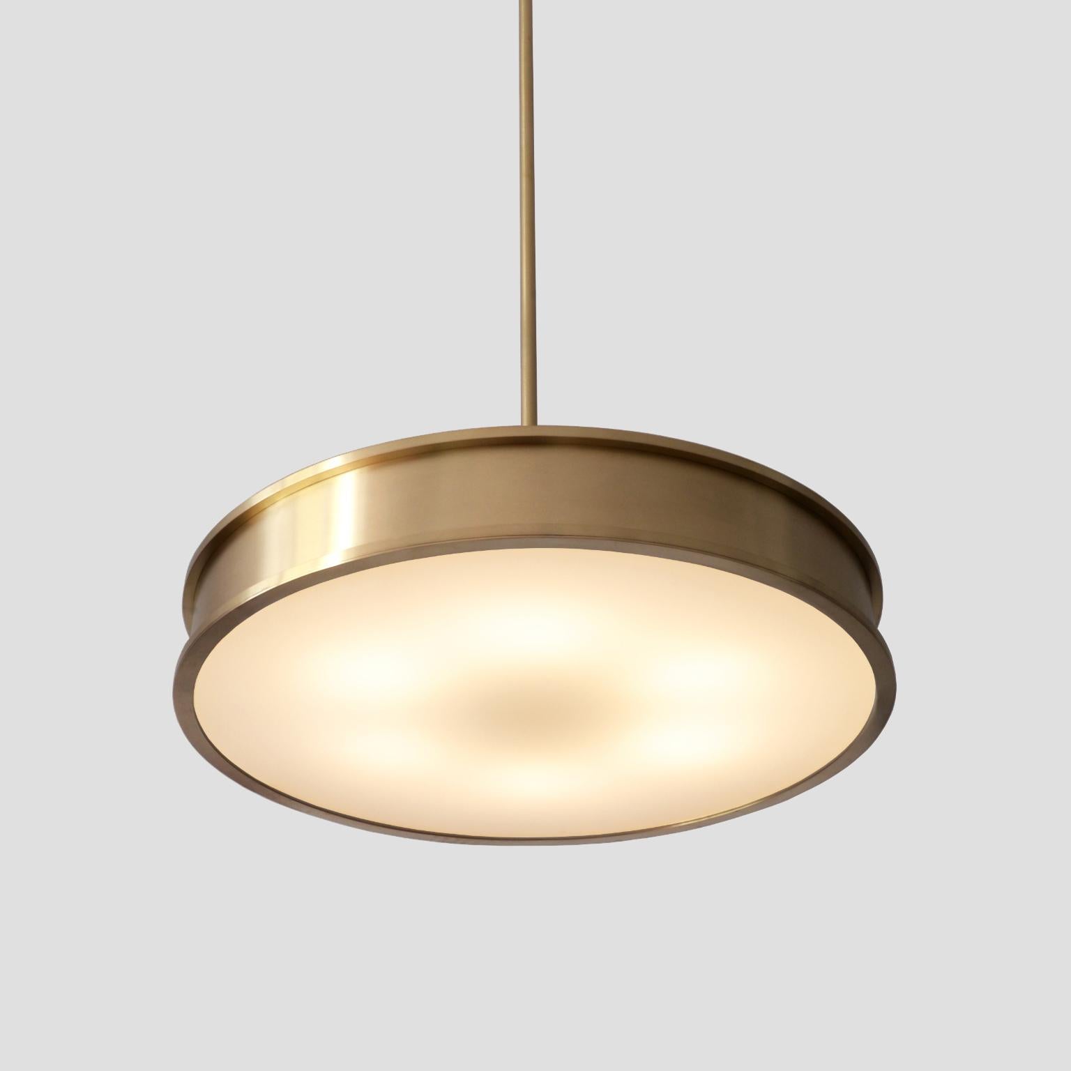 The 'Diskus' modernist pendant light has a pure classical timeless form and is manufactured in brushed brass and opal glass. The light is provided with 6 E27 sockets and disponible on request in different dimensions and amounts.