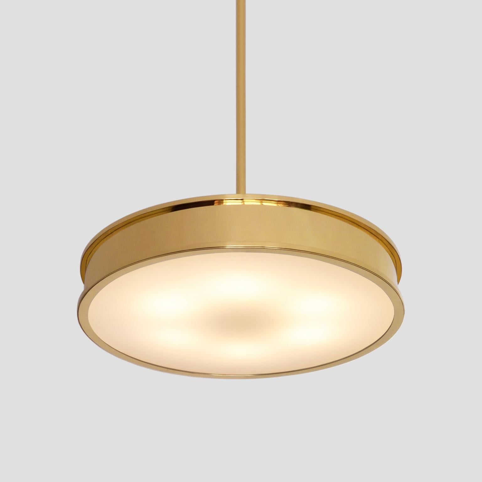 The modernist pendant light 'Diskus' with a pure classical timeless form is manufactured in polished brass and opal glass and provided with 6 E27 sockets. The light is designed by GMD Berlin - Studio and disponible on request in different dimensions