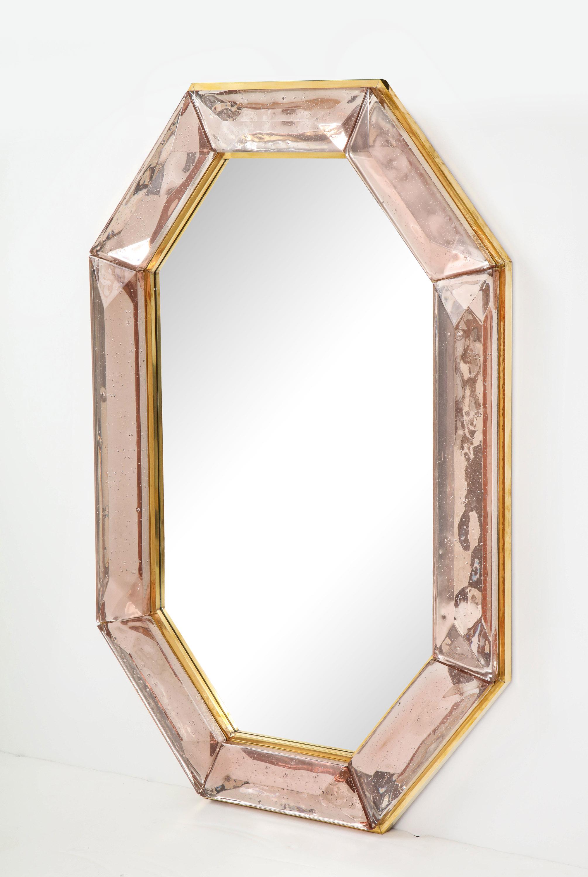 Bespoke octagon pink Murano glass mirror, in stock
Vivid and intense pink glass block with naturally occurring air inclusions throughout
Highly polished faceted pattern
Brass gallery all around
Each mirror is a unique luxury handcrafted by a