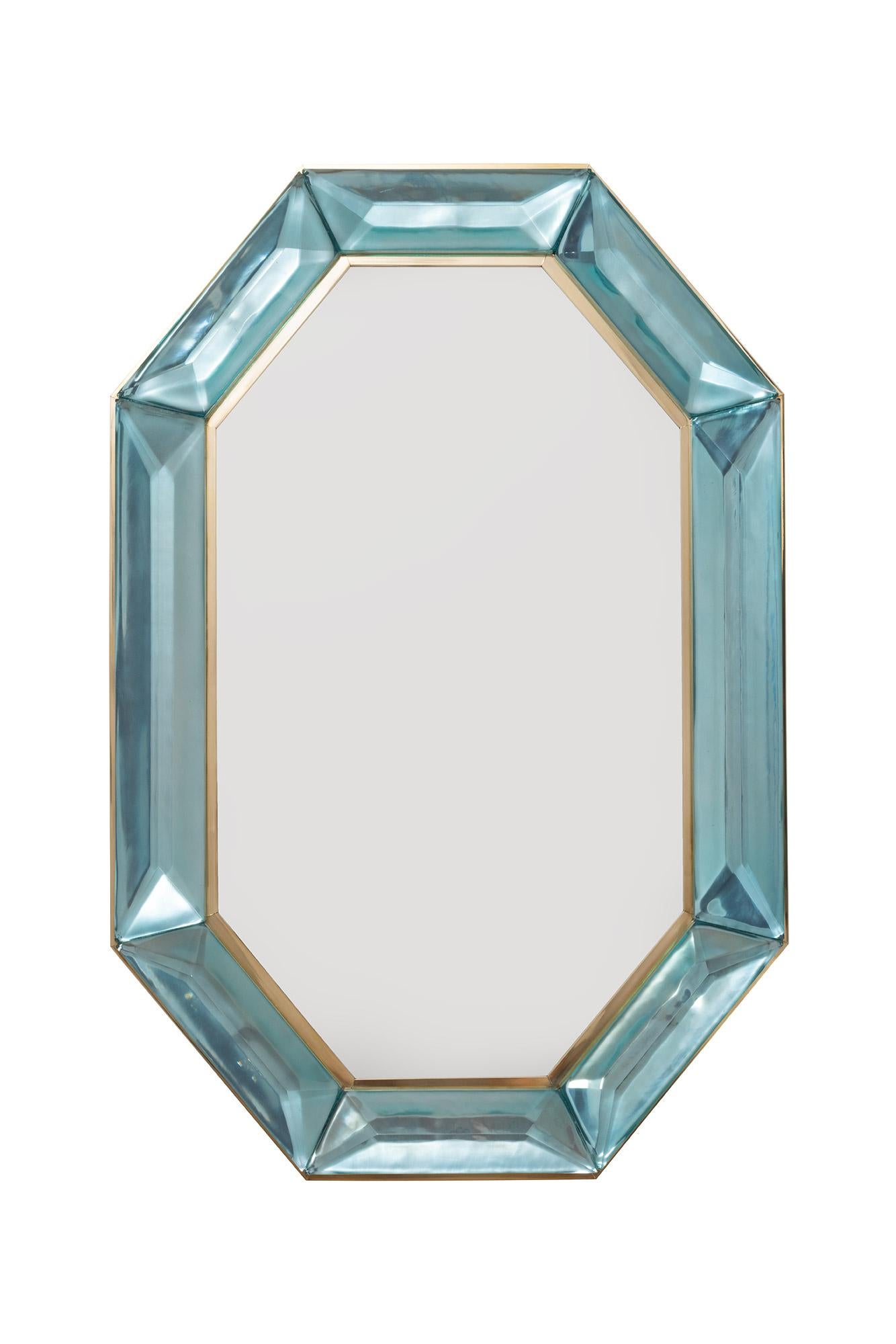 Bespoke octagonal Tiffany blue Murano glass and brass mirror, in stock
Vivid and intense Tiffany blue glass block with naturally occurring air inclusions throughout
Highly polished faceted pattern
Brass gallery all around
Each mirror is a unique