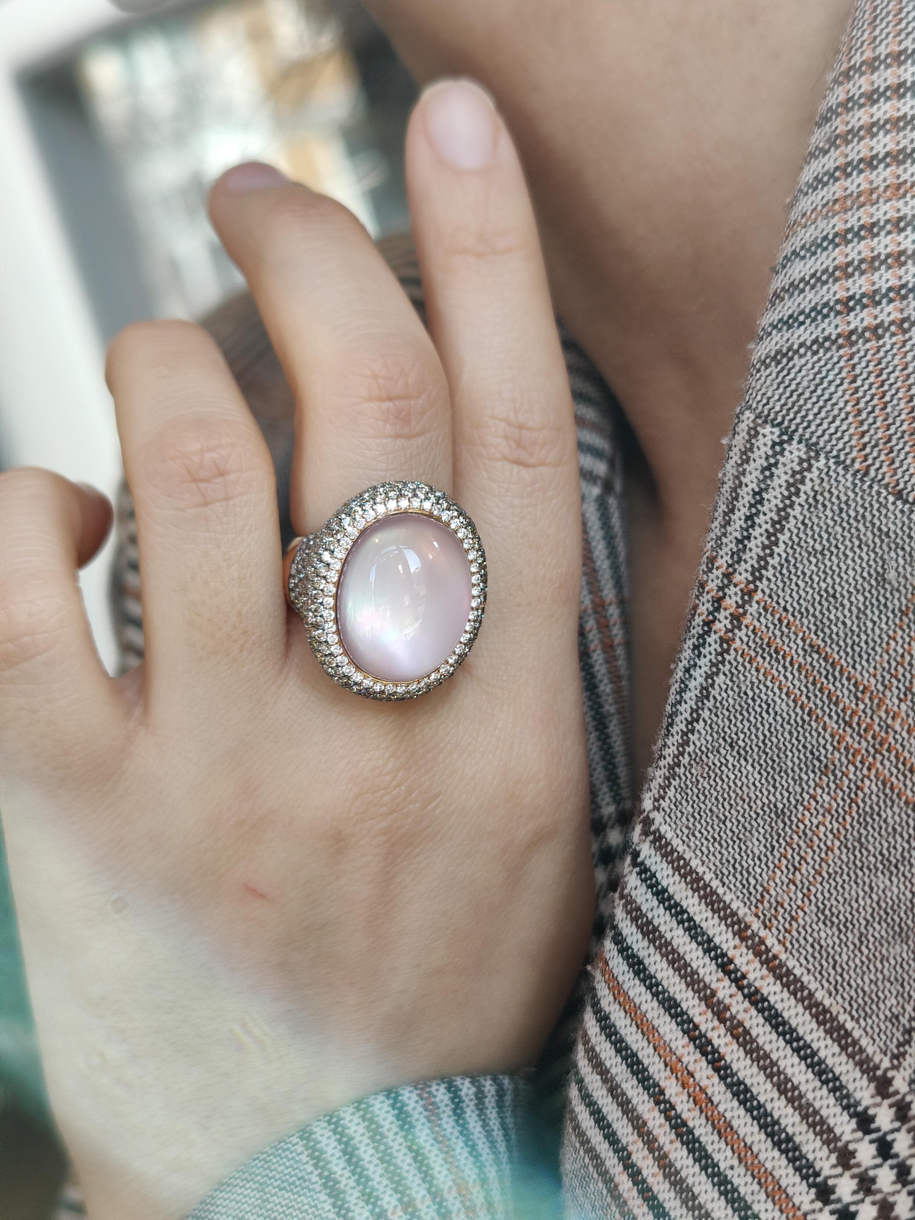 The  beautiful soft pink colour of the cabochon oval cut rose quartz is accentuated by 0.32 carat white pavé diamonds encircling the rose quartz and are set in an 18 karat rose gold setting.

Around this sparkling line of diamonds a total of 3.45