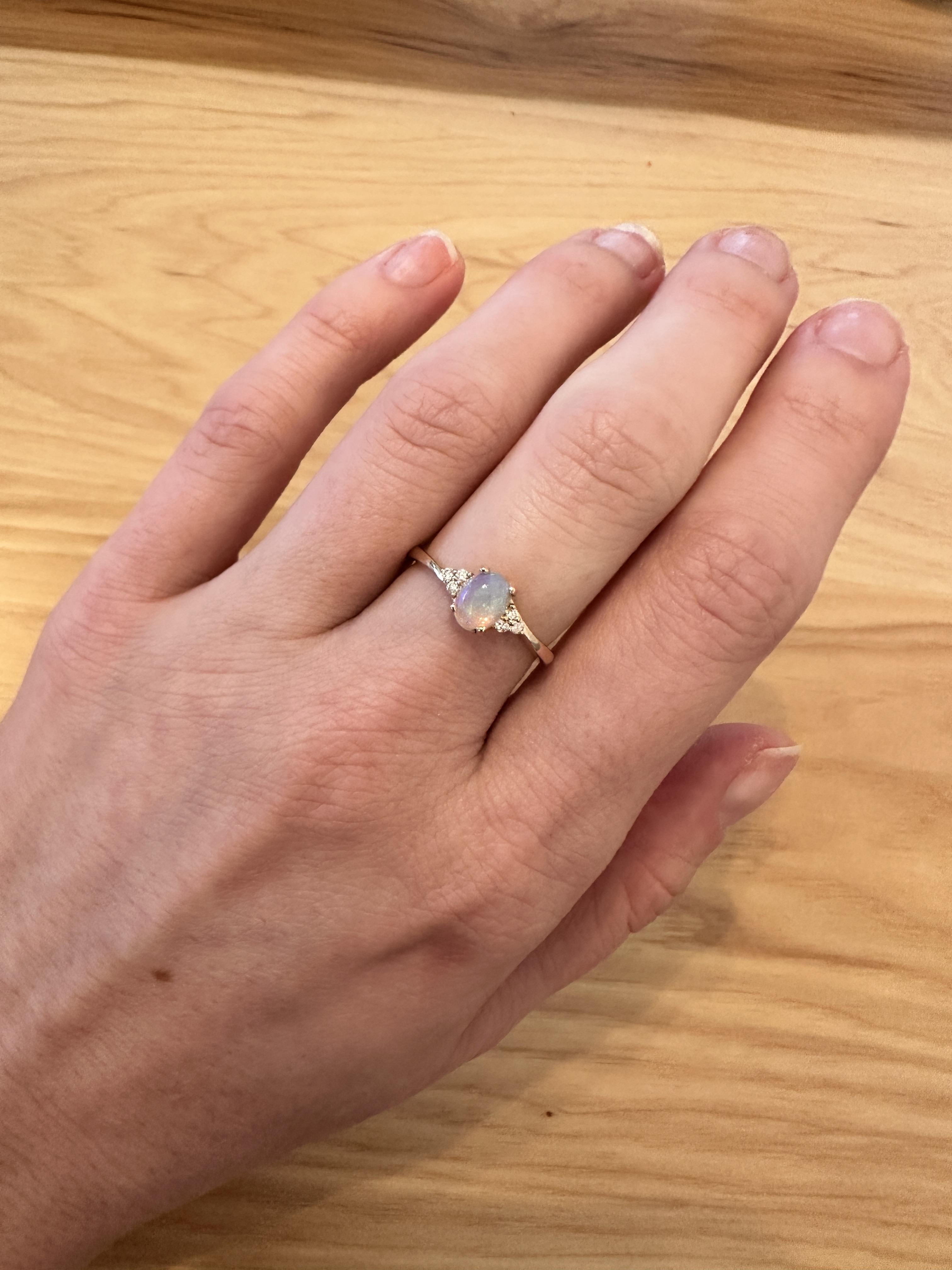 This ring features an oval 0.64 carat Opal gemstone with natural earth mined diamonds set in solid 14K gold. Crafted with precision, this ring is designed to be both beautiful and comfortable. This Opal ring also makes a beautiful October birthstone