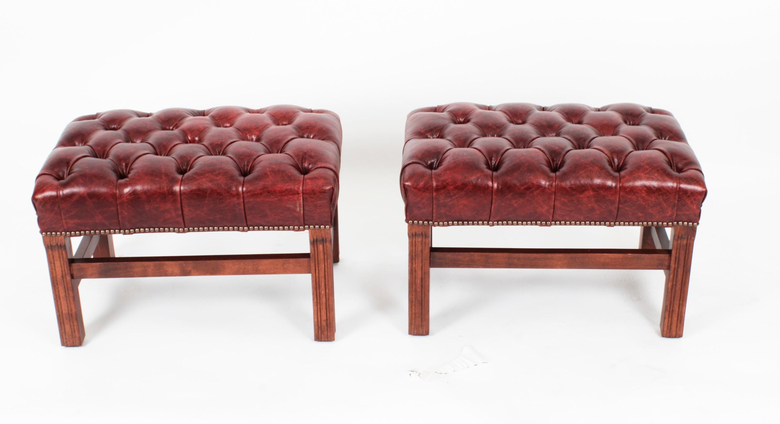 This is a very handsome bespoke pair of leather stools in crimson leather, the colour is called Murano Port.

They feature fantastic beautiful sumptuous buttoned leather upholstery and are raised on square tapering legs joined by H
