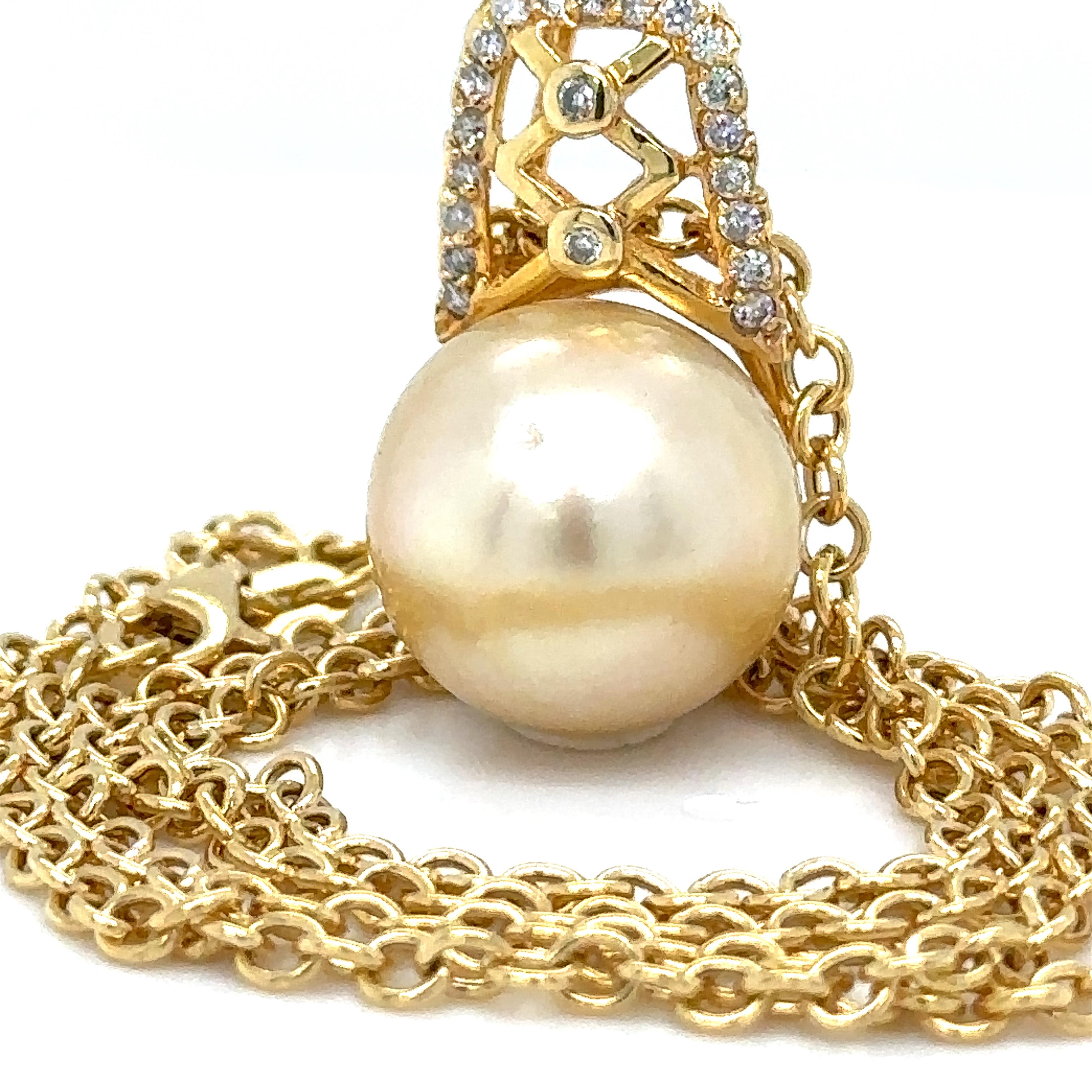 A Pearl And Diamond Pendant And Chain. South Sea cultured pearl is set in 18ct Yellow Gold with 21 round brilliant cut diamonds.

Suspended on an 18ct Yellow gold 46cm oval link neck chain.

Pearl size: 14.6mm, Shape: Semi-round, Colour: Champagne,