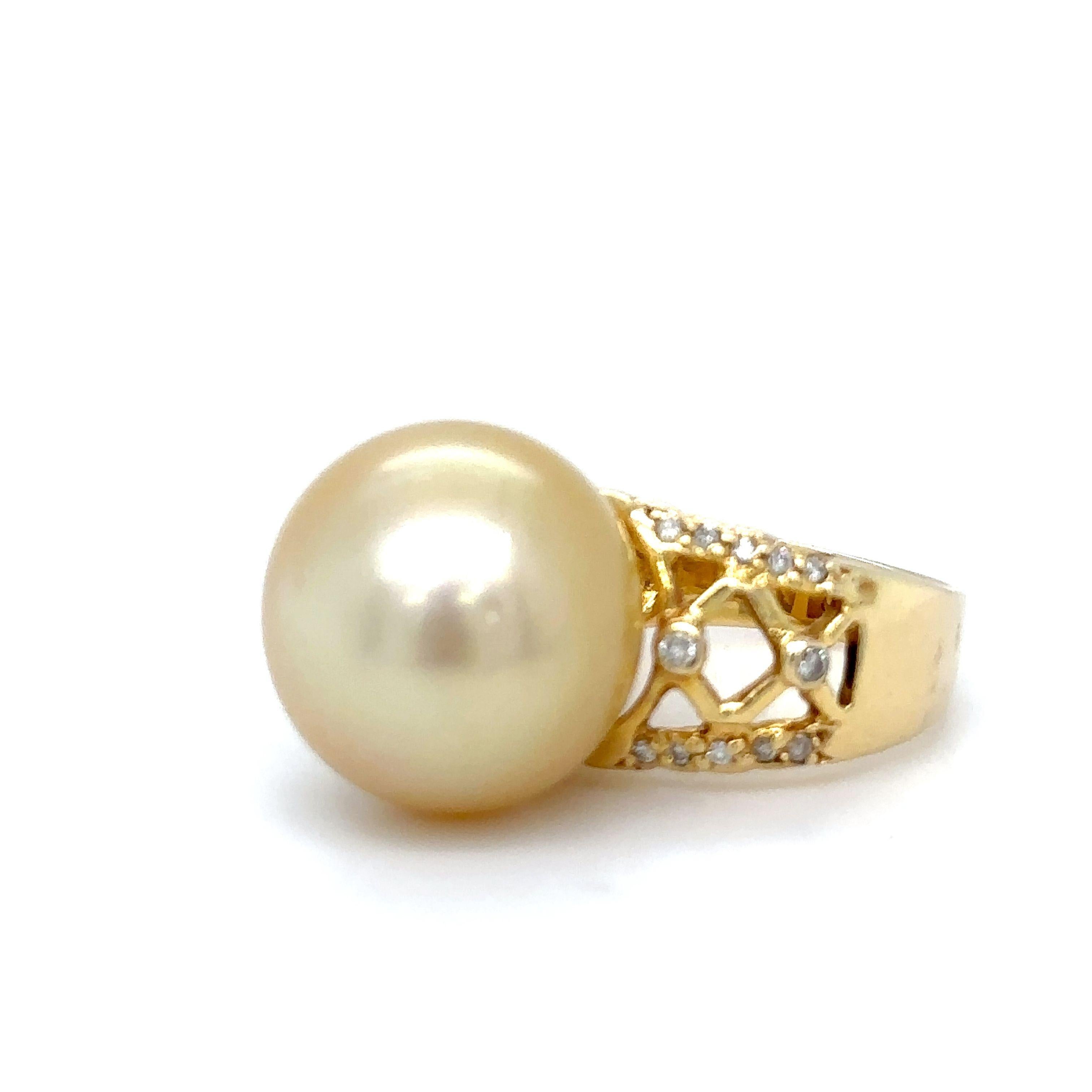 A Pearl and Diamond Ring, with a 15.2mm South Sea cultured pearl and 24 round brilliant cut diamonds on the shoulders and set in 18ct Yellow Gold.

Pearl size: 15.2mm, Shape: Semi-round,

Colour: Light Golden, Lustre: Medium, Surface: