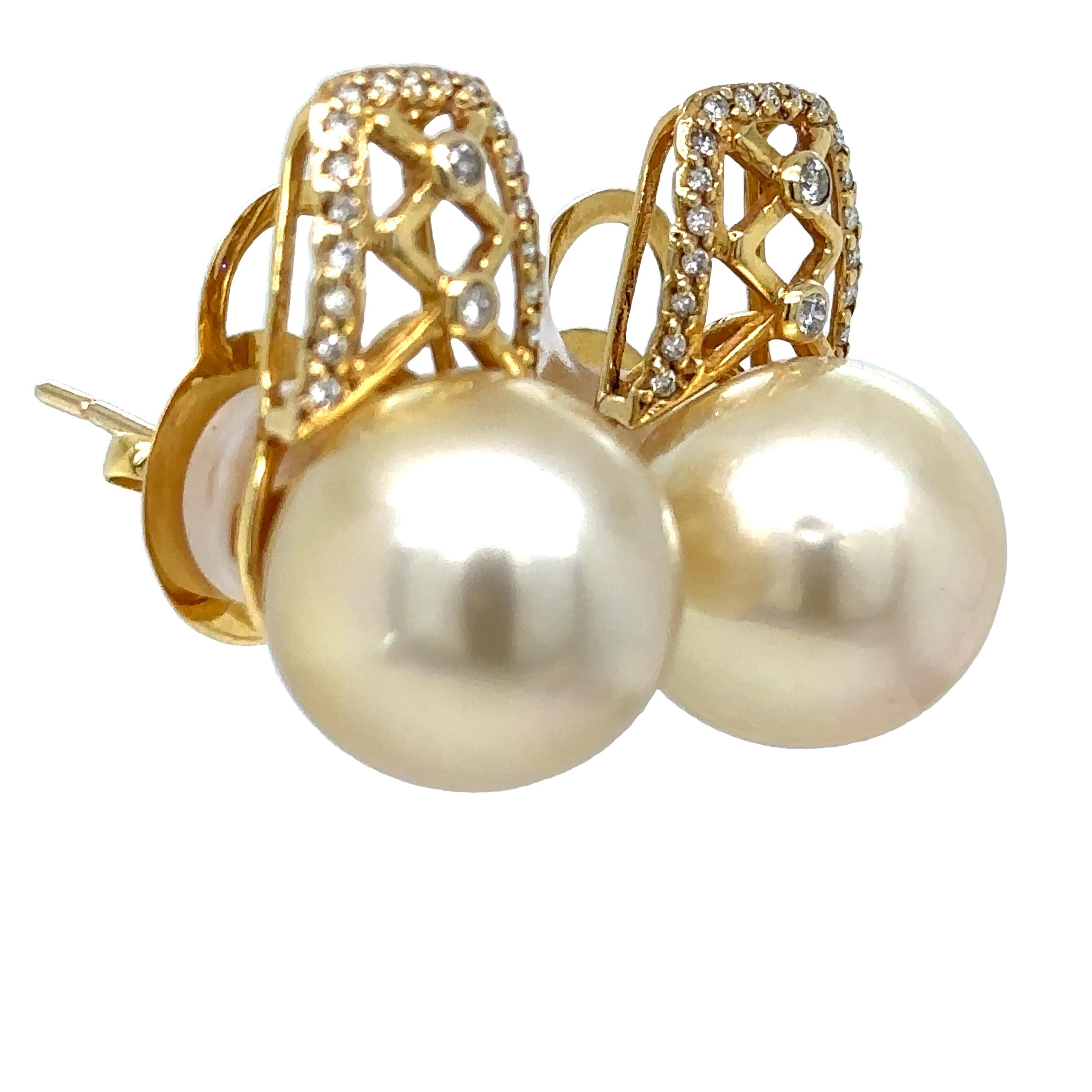 A Pair Of Pearl And Diamond Stud Earrings. Each earring with a 14.5-15.0mm South Sea cultured pearl and 21 round brilliant cut diamonds are set in 18ct yellow gold.

Pearl size: 14.6 - 15.0mm, Shape: Semi-round, Colour: Champagne, Lustre: Medium,