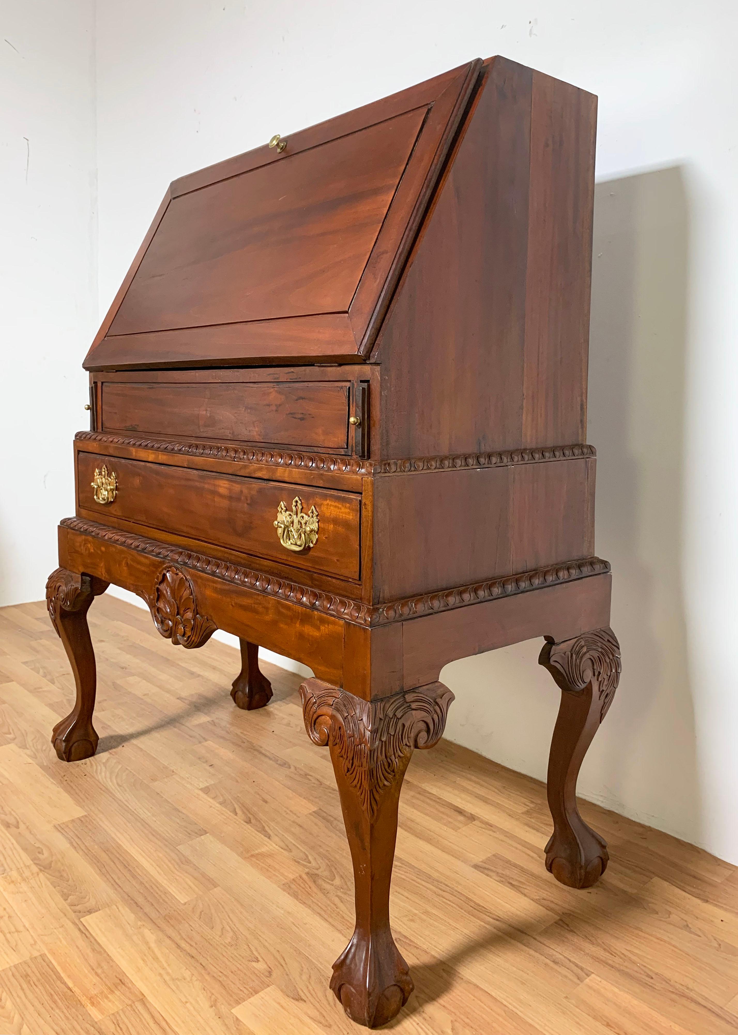 Custom hand built Queen Anne style drop front desk on frame with carved cabriole legs, gadrooned edges and shell carved apron. In solid mahogany boards with brass hardware, circa mid 20th century.

Measures: 41.5