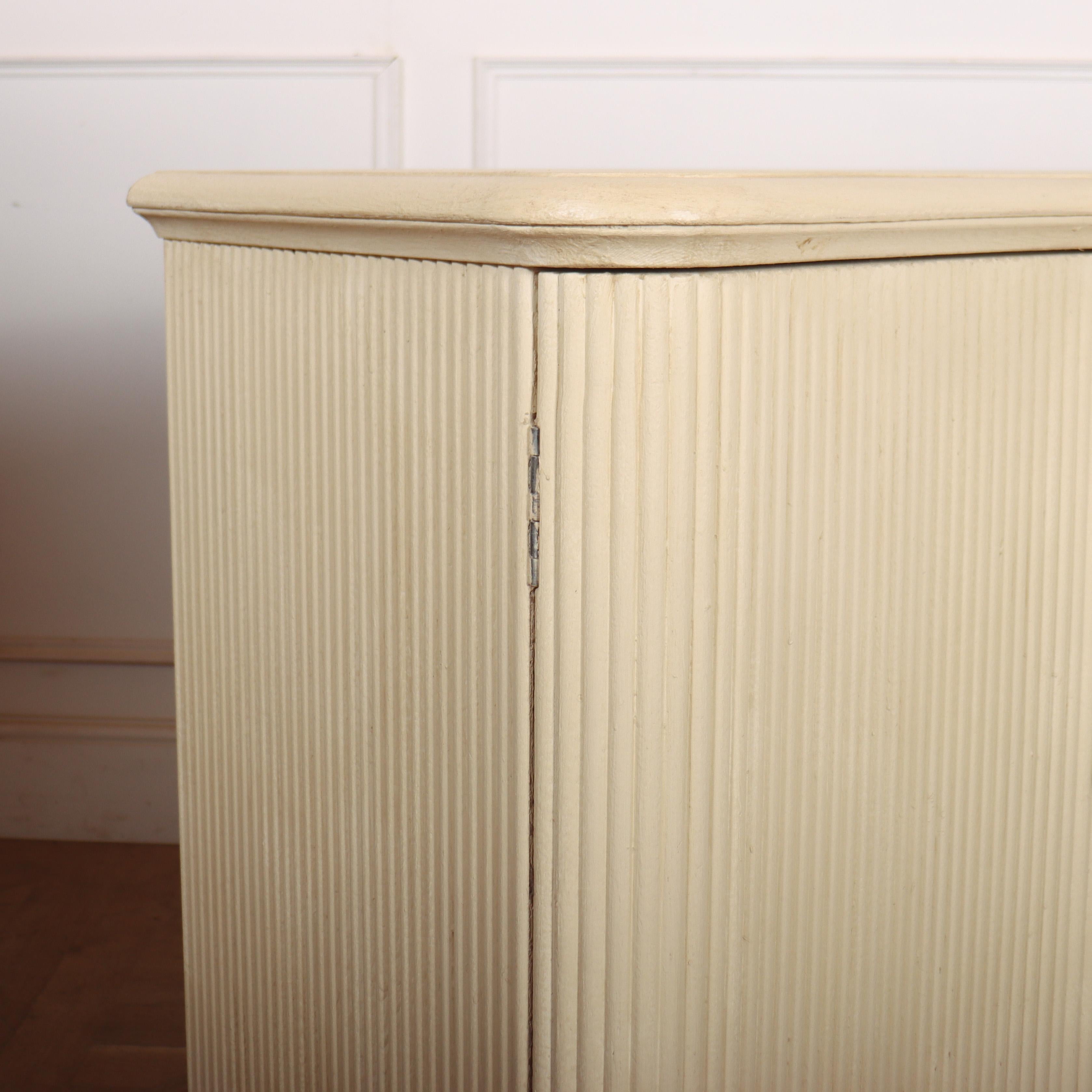 Bespoke four door serpentine front sideboard with ribbed doors and standing on bun feet. 

- This one is painted in Paint and Paper Library 'Paper IV'.

- Five more are available to be painted in a colour of your choice. 

- This is only available