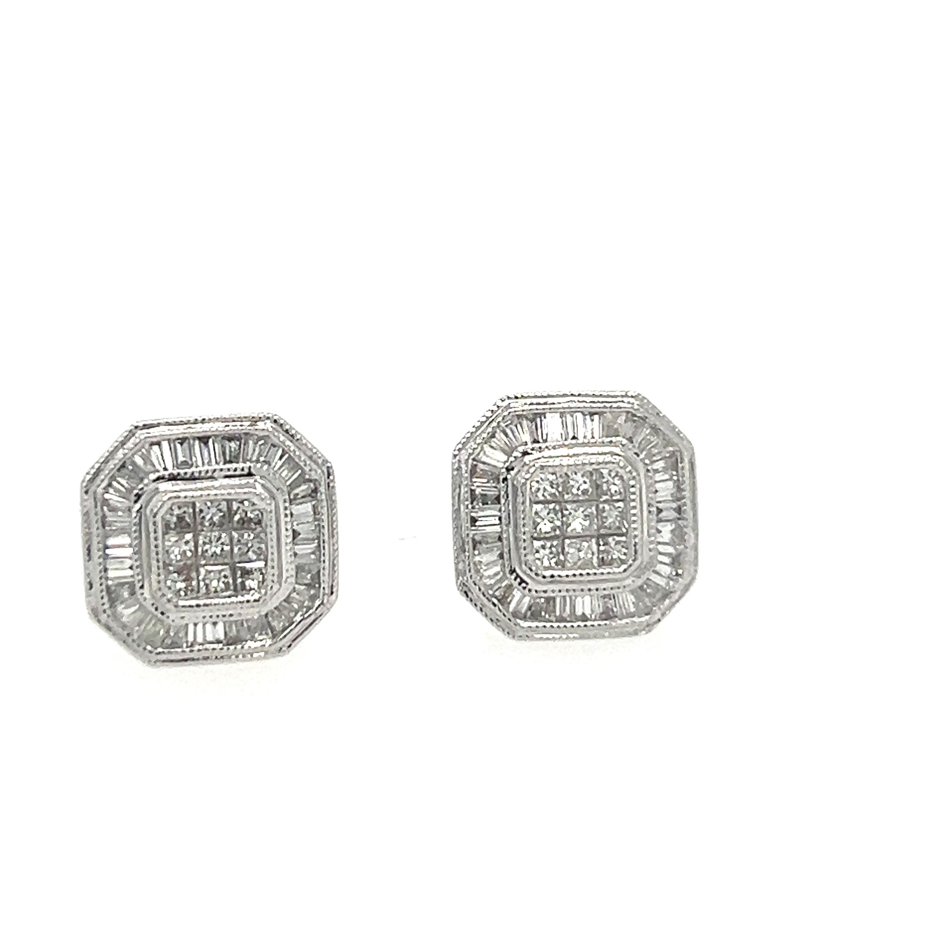 A Pair Of Diamond Square Cut-Cornered Diamond Cluster Stud Earrings.

Each earring with 9 invisible set princess cut diamonds within a border of 32 tapered baguette cut diamonds channel set in 18ct white gold.

Diamonds 82 = 0.75ct