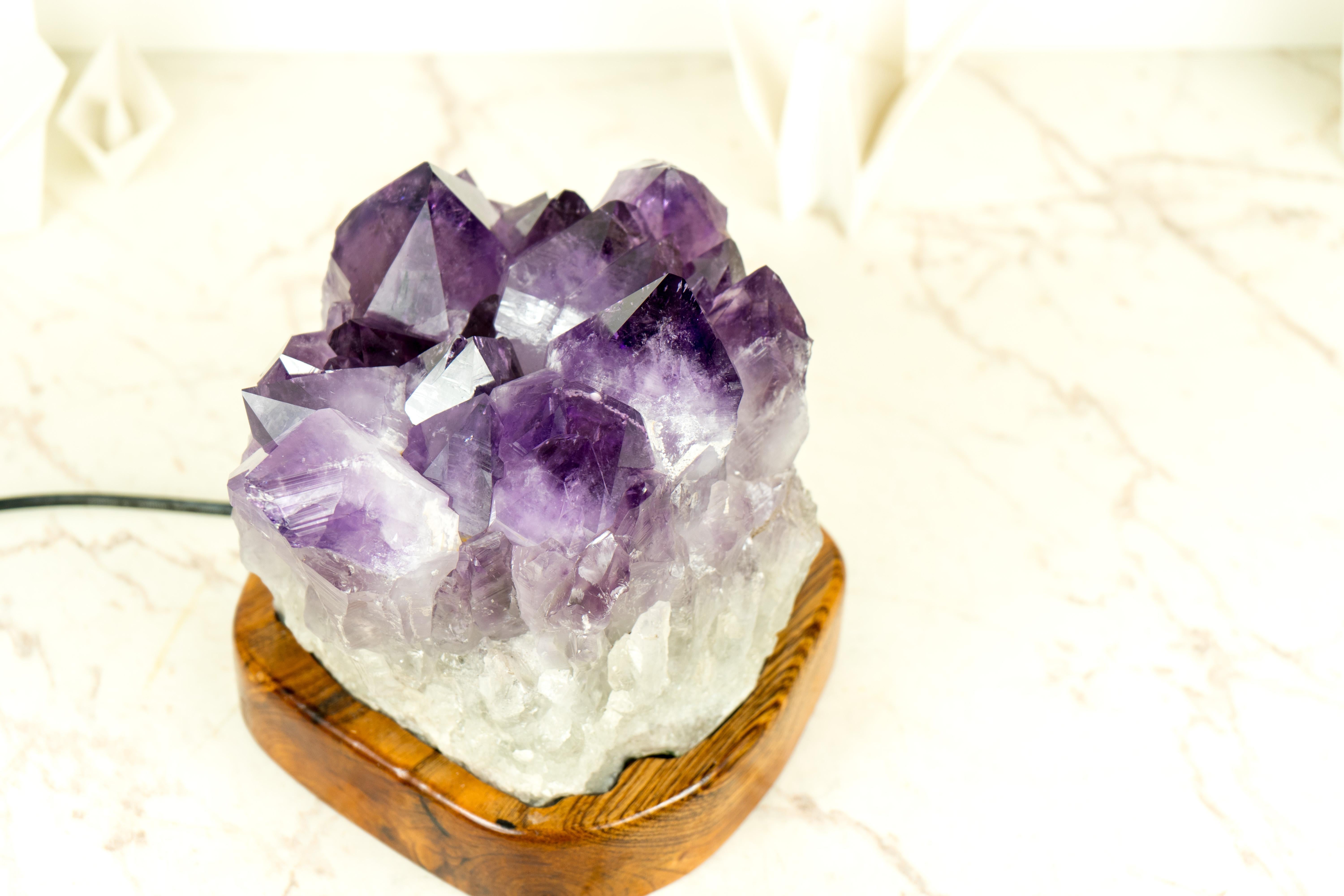 Designed by E2D Crystals, this Amethyst Geode Cluster table lamp is a one-of-a-kind item, created with a focus on uniqueness, quality, and beauty. We used only the best materials, bespoke craftsmanship, and the most unique Amethyst we could find to