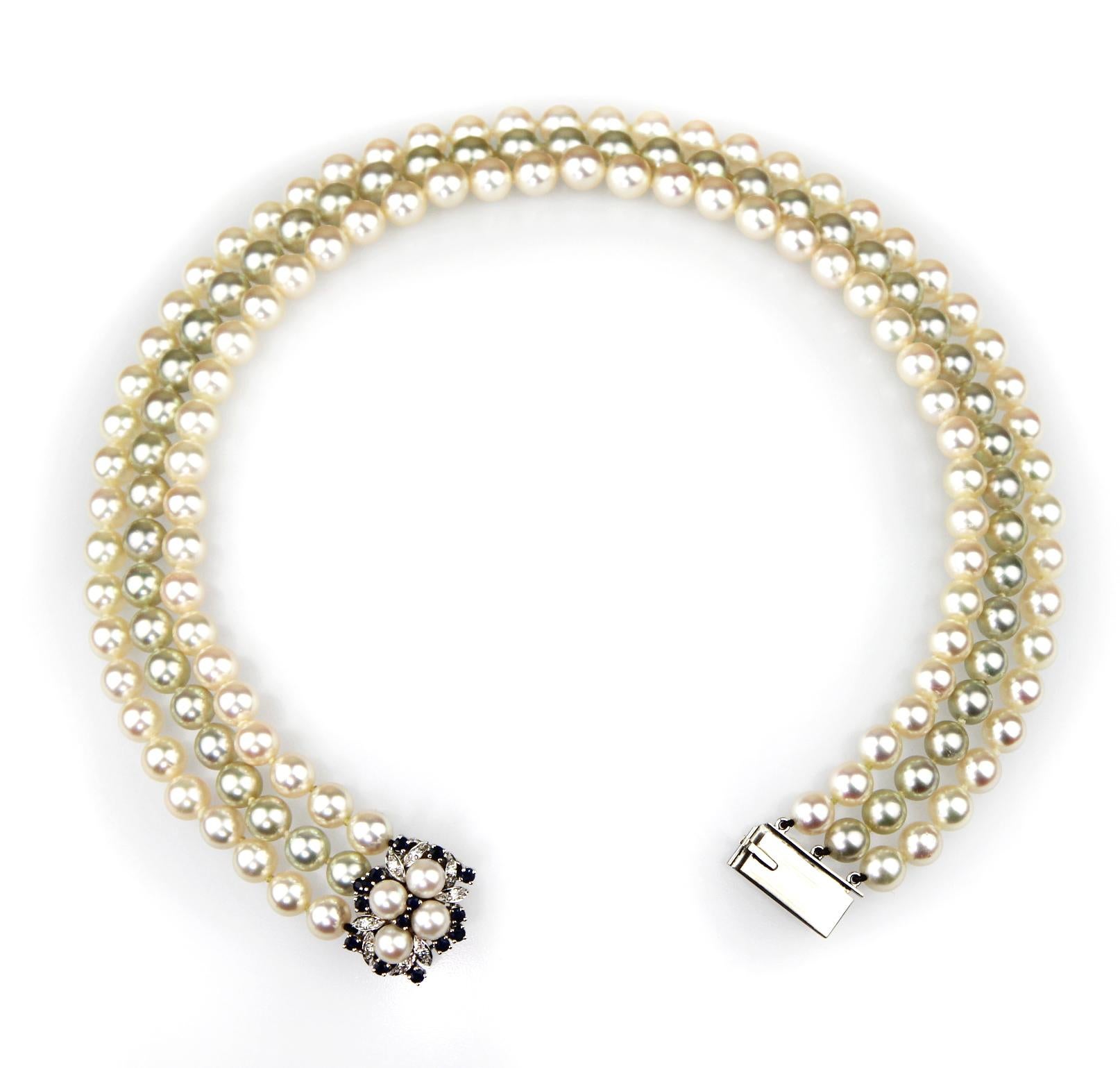 Three row pearl necklace, consist of different overtones of grey row center with pink rows on the sides, all rippling effortlessly among one another, complementing each other's colours. Beautiful custom made the hidden box clasp with four pearls