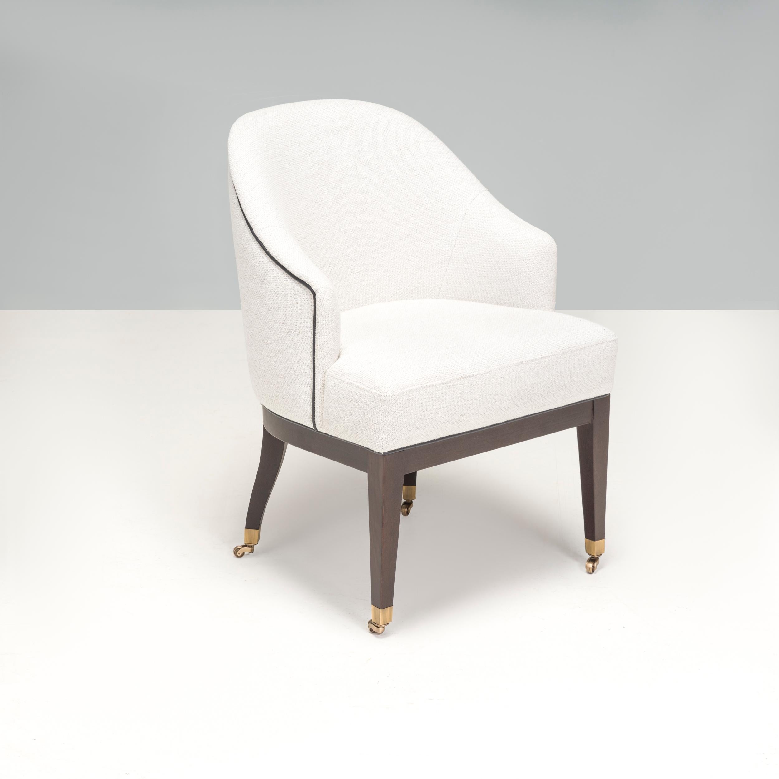 This traditional upholstered office chair with piping has an impressive design that would elevate any living space or bedroom. Its neutral colour palette means it would harmonise well with a range of interior aesthetics. The back of the chair curves