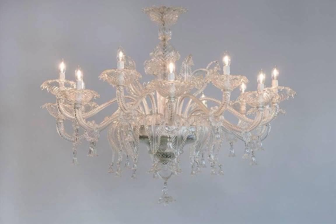 Lampadario italiano su misura in vetro di Murano, colore chiaro, Italia.
Questo bellissimo e raffinato lampadario italiano in vetro trasparente, interamente soffiato a mano, è una produzione attuale,  nell'isola veneziana di Murano ed è attribuito