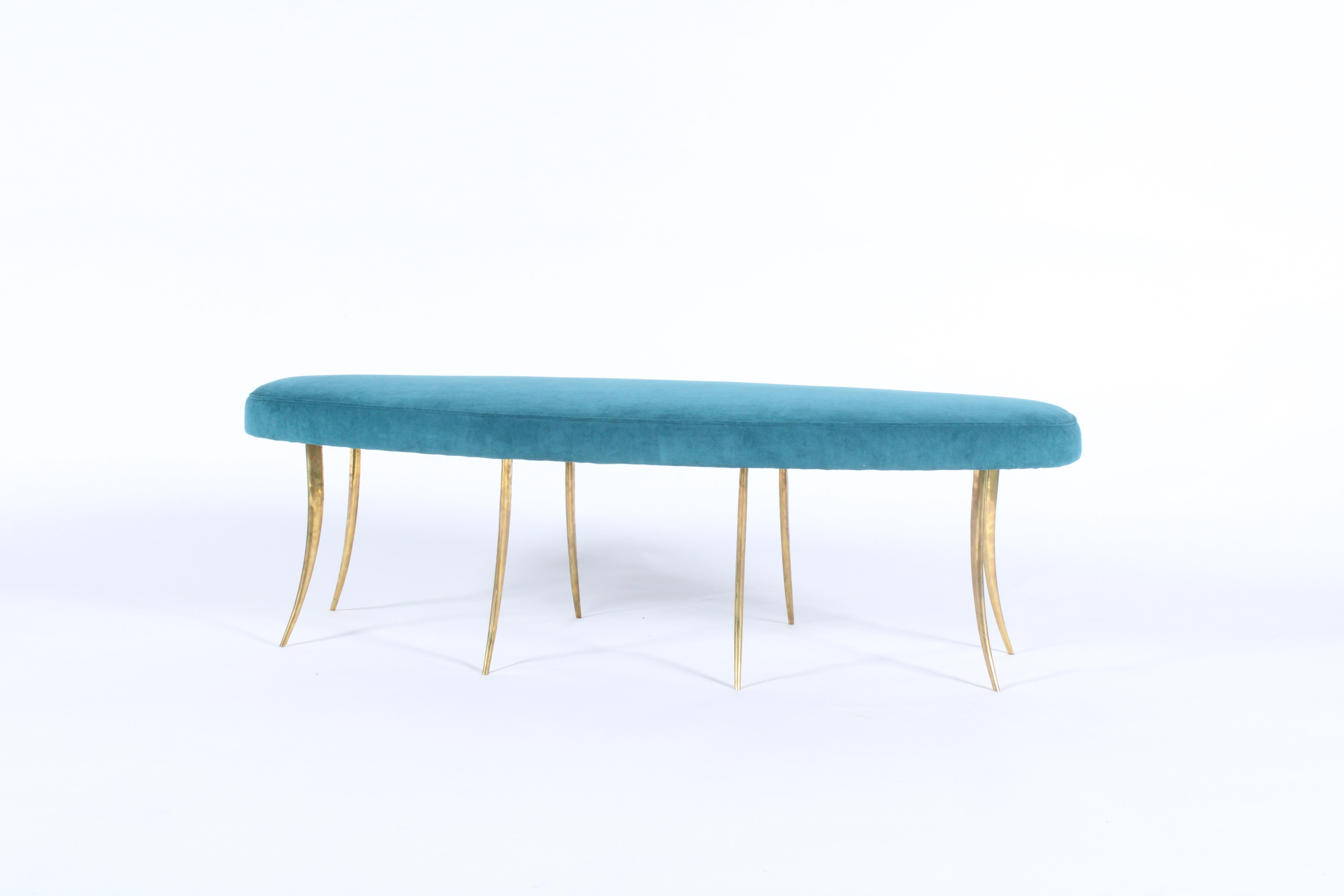 A striking bespoke bench rich in design and Italian style. A newly upholstered luxurious cushion in teal fabric sits atop eight curved brass feet which have a wonderful vintage patina.. This is a unique piece and will work superbly in a wide variety