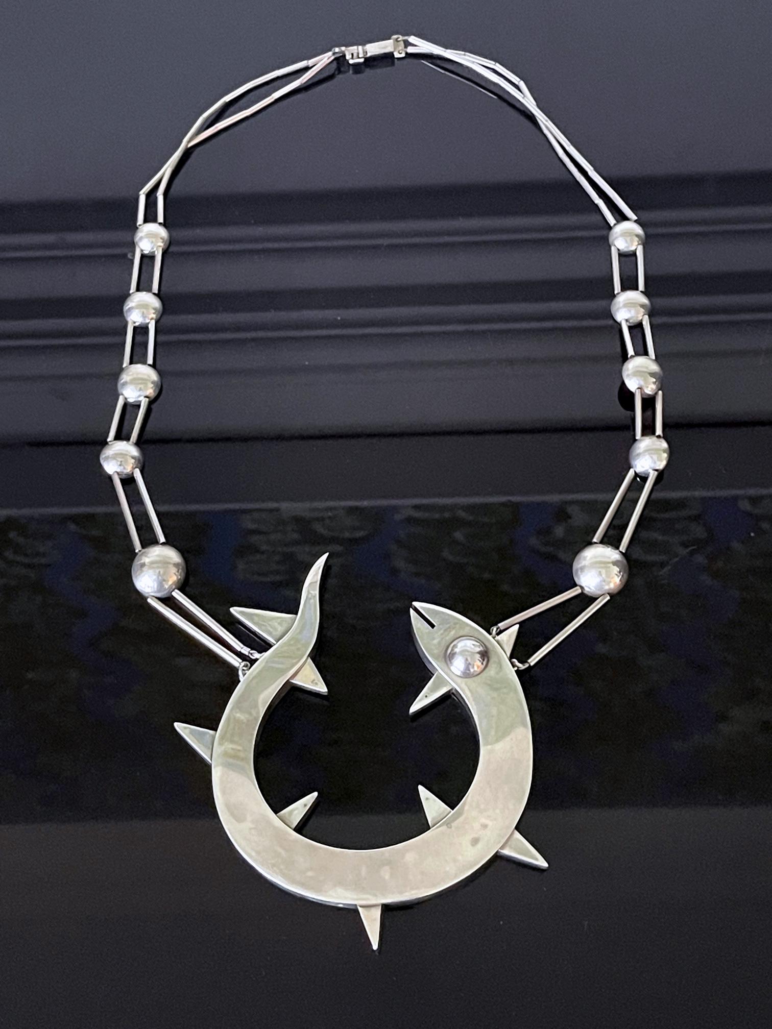 A highly sculptural sterling silver necklace by Peruvian silversmith and designer Grazielle Laffi (1923-2009), Lima, circa 1970. Marks to necklace: PERU, 950. The necklace has a very modern appearance and features an articulate chain links made of