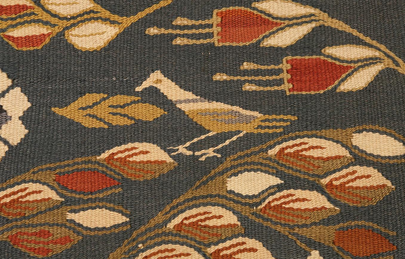 This stunning Bessarabian Kilim, measuring 295 x 198 cm, is a captivating piece of art that marries intricate design with rich cultural heritage. Each detail of this handwoven masterpiece tells a story, inviting viewers to immerse themselves in its