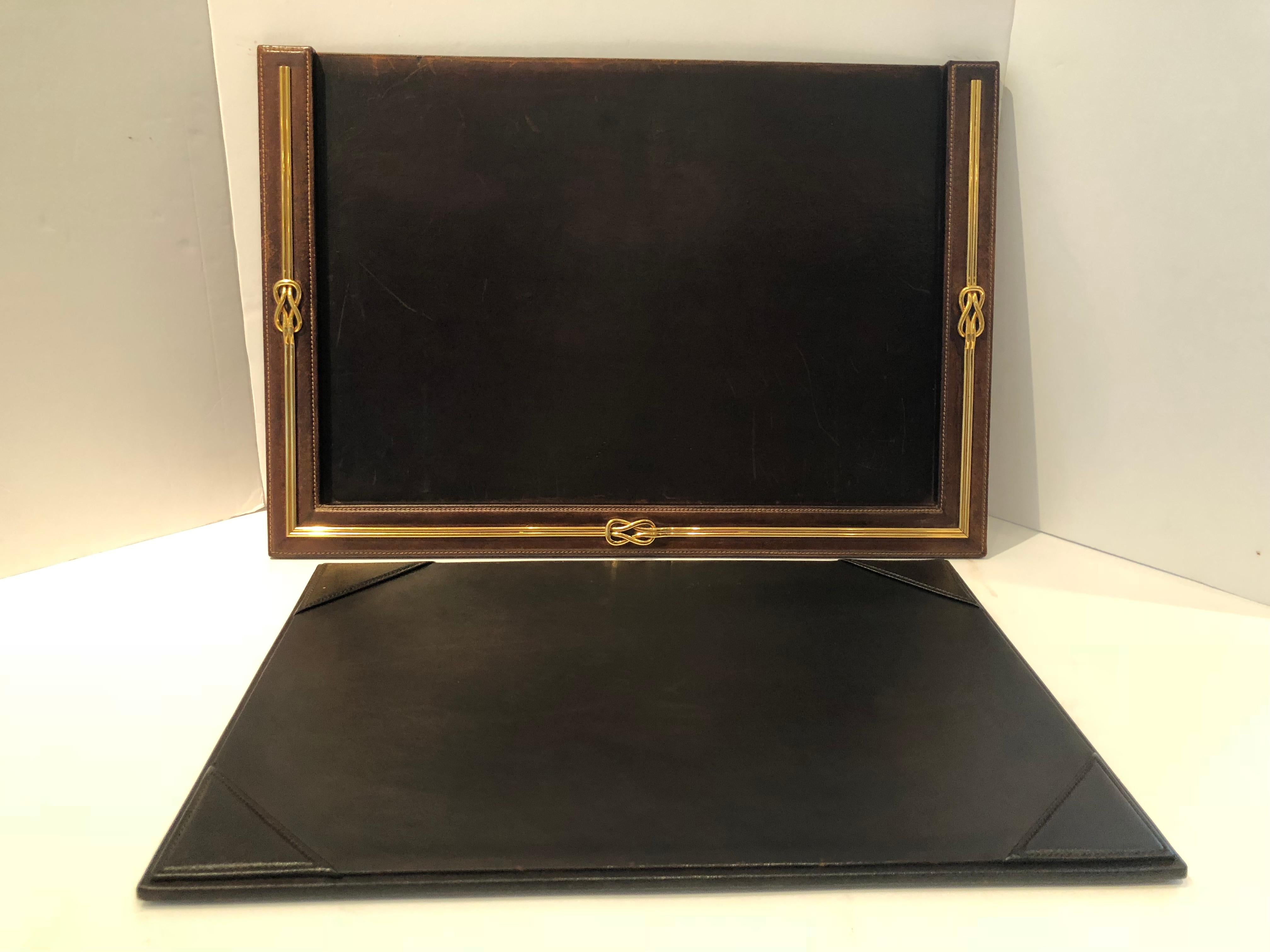 Chocolate brown leather meets thick heavy brass Gucci logo in this handsome vintage desk blotter and pen pencil holder. The blotter has a separate leather insert having four corners to hold paper in place. It is signed Made in Italy by Gucci. The