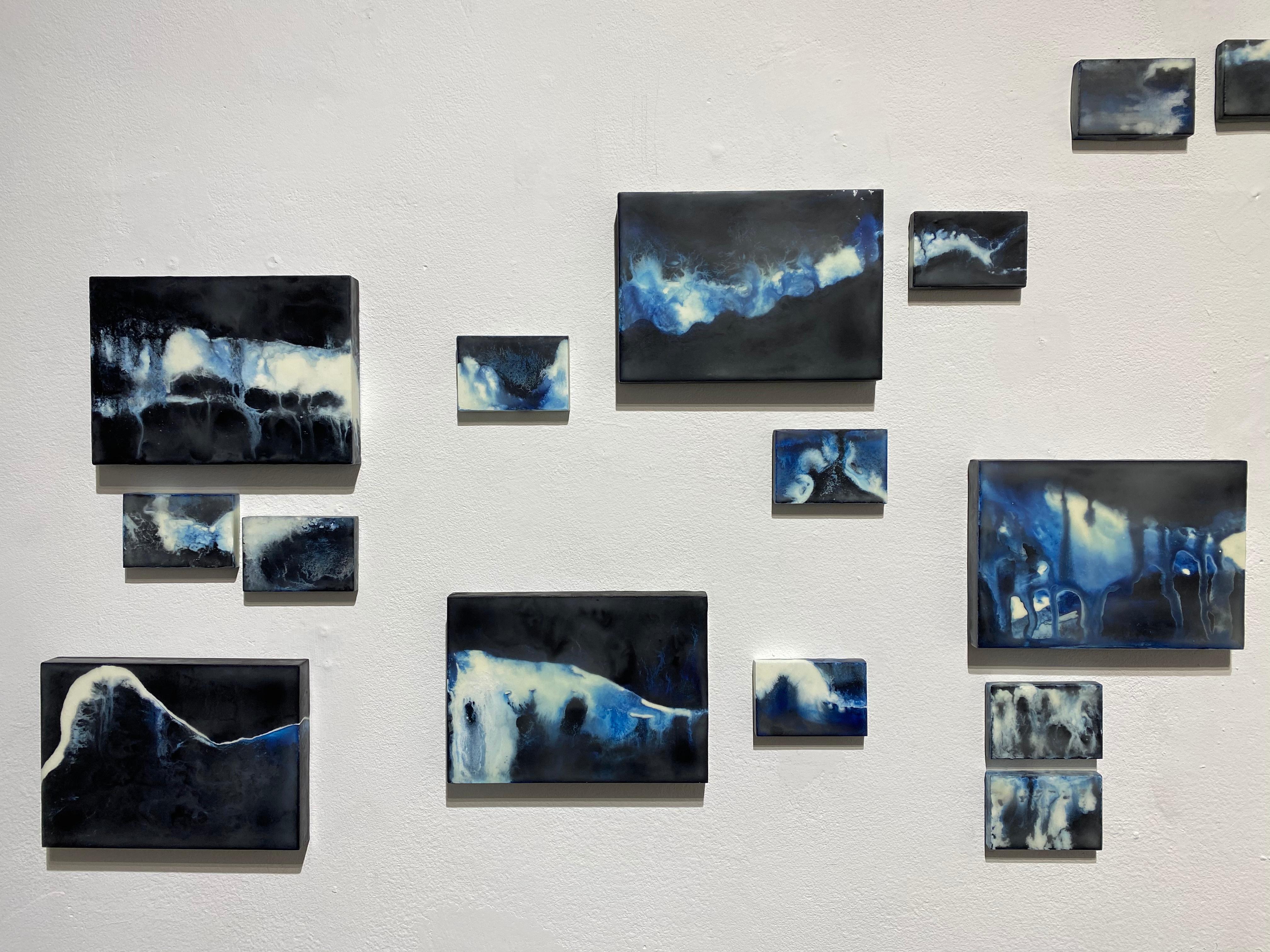 This multi panel installation evokes a visual imagery of flowing water, with deep blues, dark indigo and white.  Each panel is positioned to relate to each other as a course of water running through the visual layout of the painting installation. 