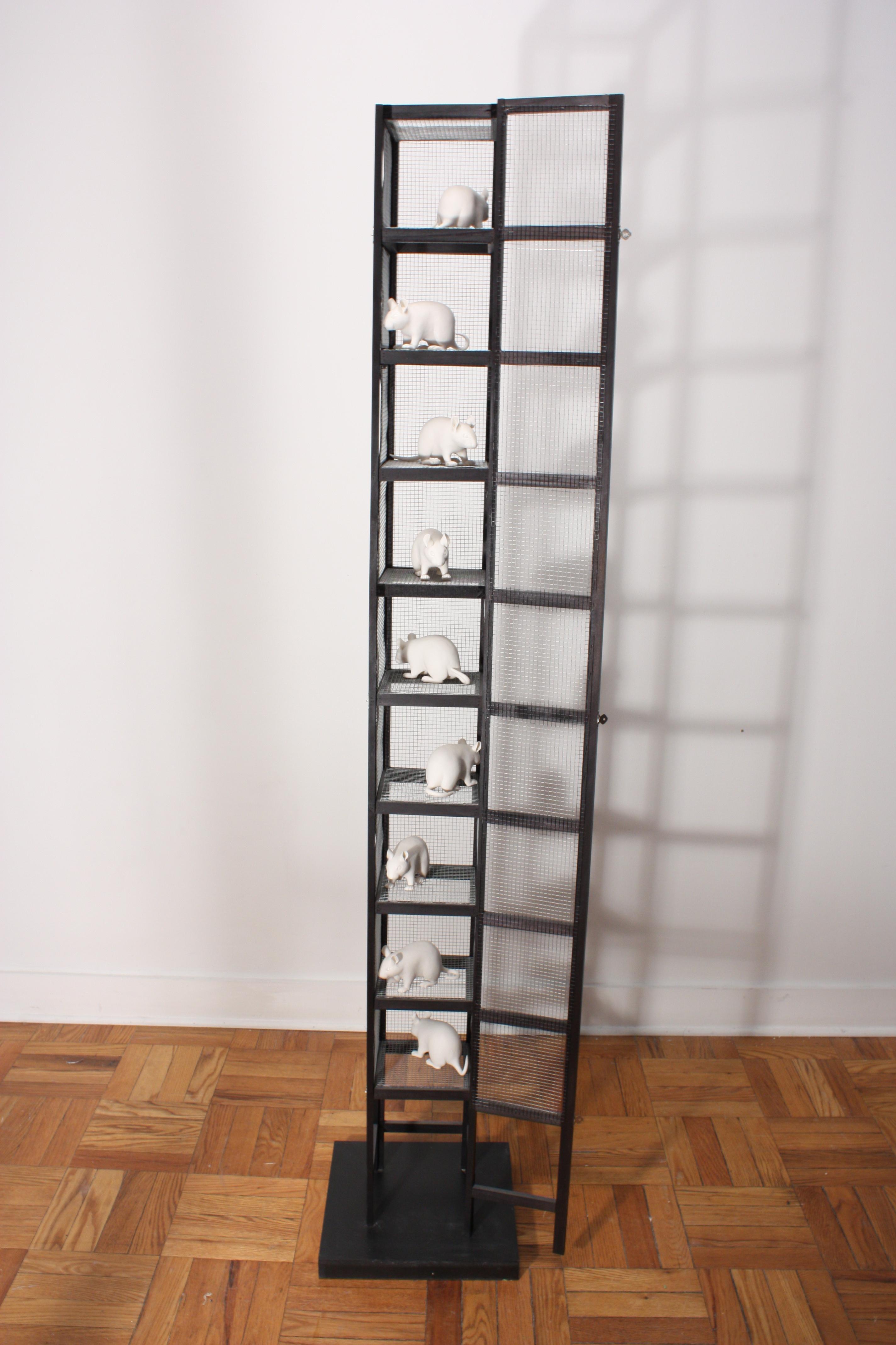 A black tower of stacked cages holds nine white porcelain mice which have been carefully slip-cast and assembled by the artist Bethany Krull.  The beautiful porcelain surface is left raw and unglazed except for the eyes and nose which are finished