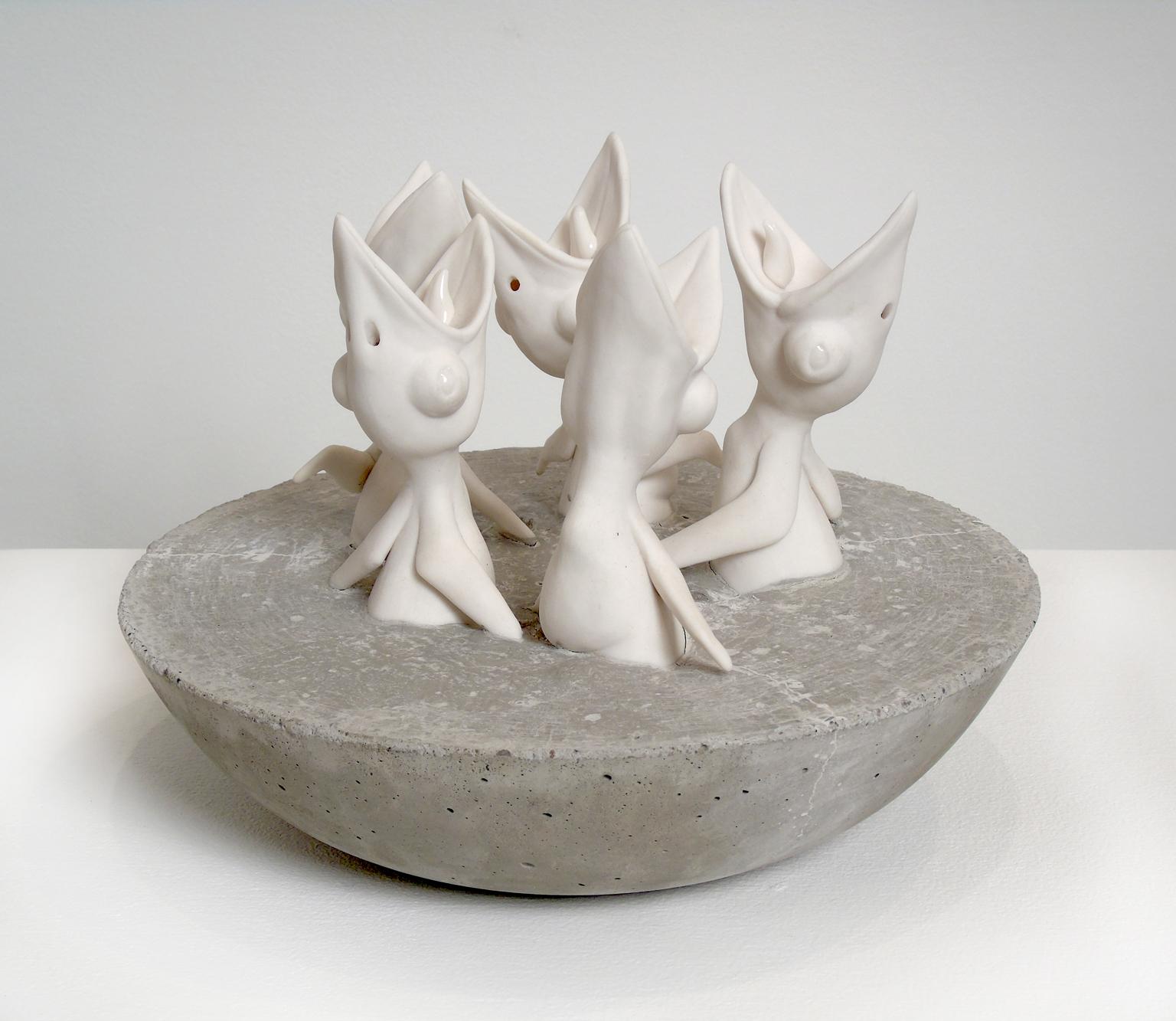 "Five Hungry Birds" by Bethany Krull shows five baby birds, mouths agape and reaching up from a concrete base. Krull's presents her porcelain creatures in absurd and tense scenarios. Such is the case with "Five Hungry Birds". The chicks are bare and