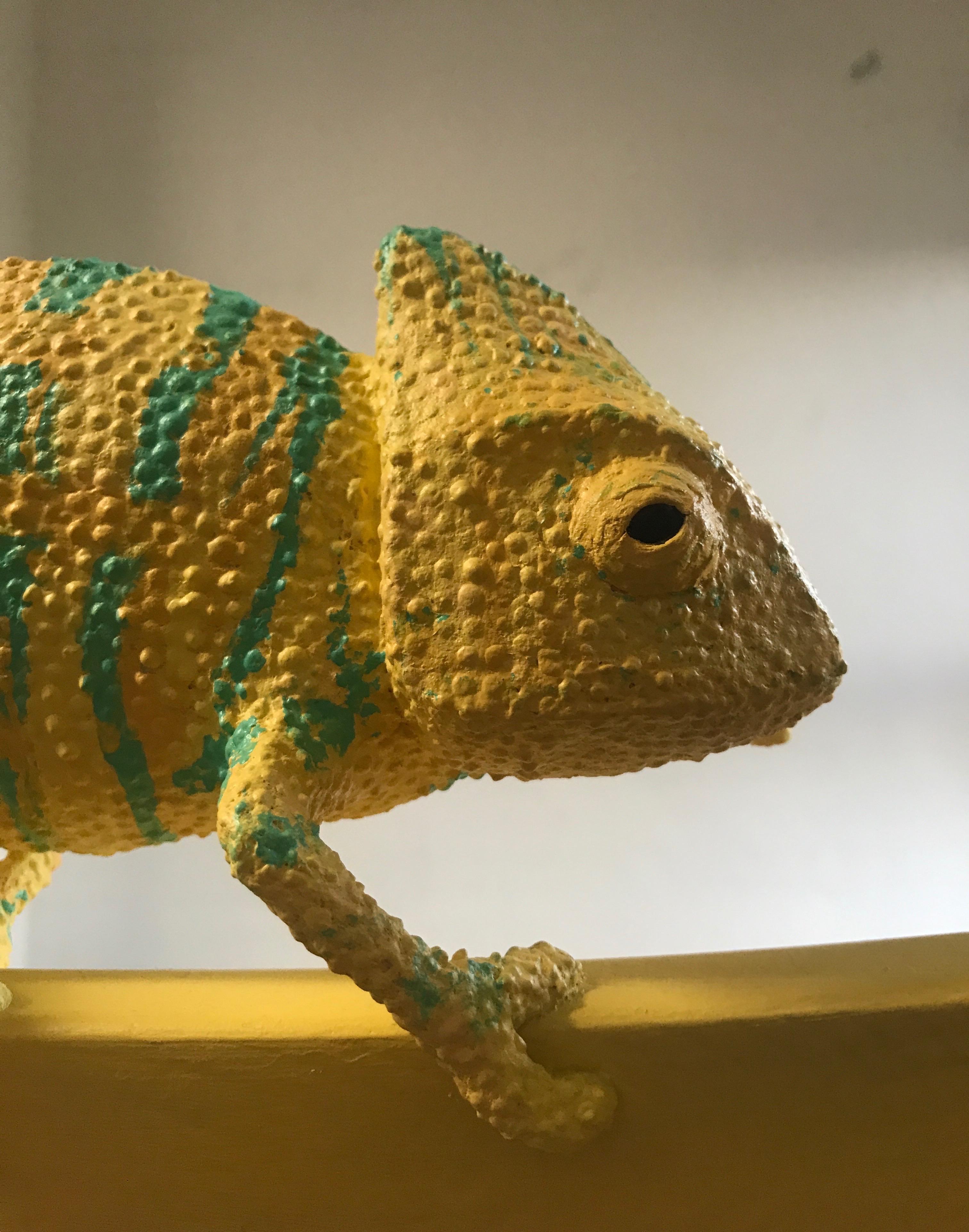 Paper Mache chameleon on a yellow chair 