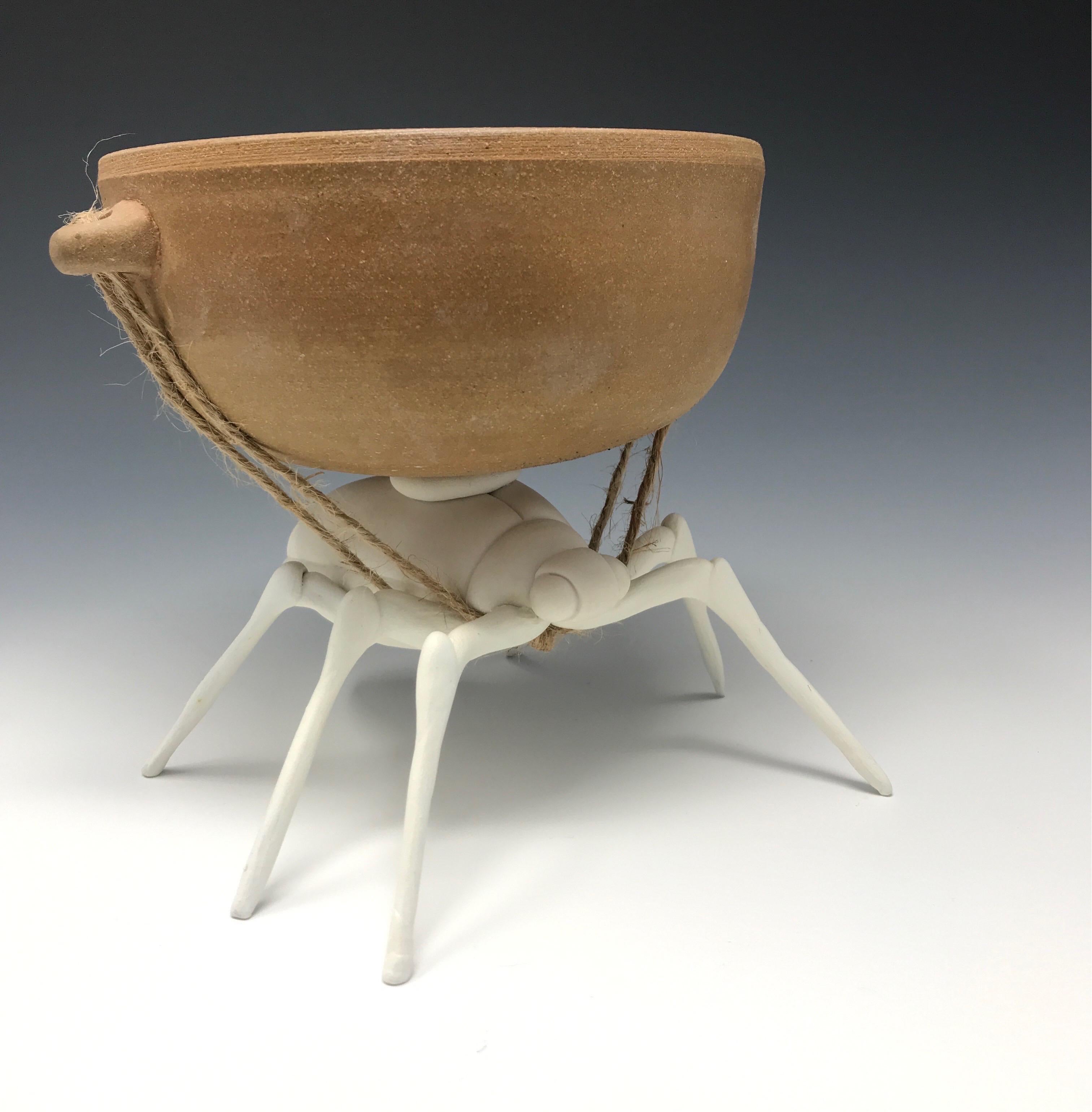 This hand built porcelain beetle with resilient wire and epoxy clay legs hauling a wheel-thrown earthenware bowl was created by New York artist, Bethany Krull.  A thought provoking functional serving vessel that questions the idea of servitude is