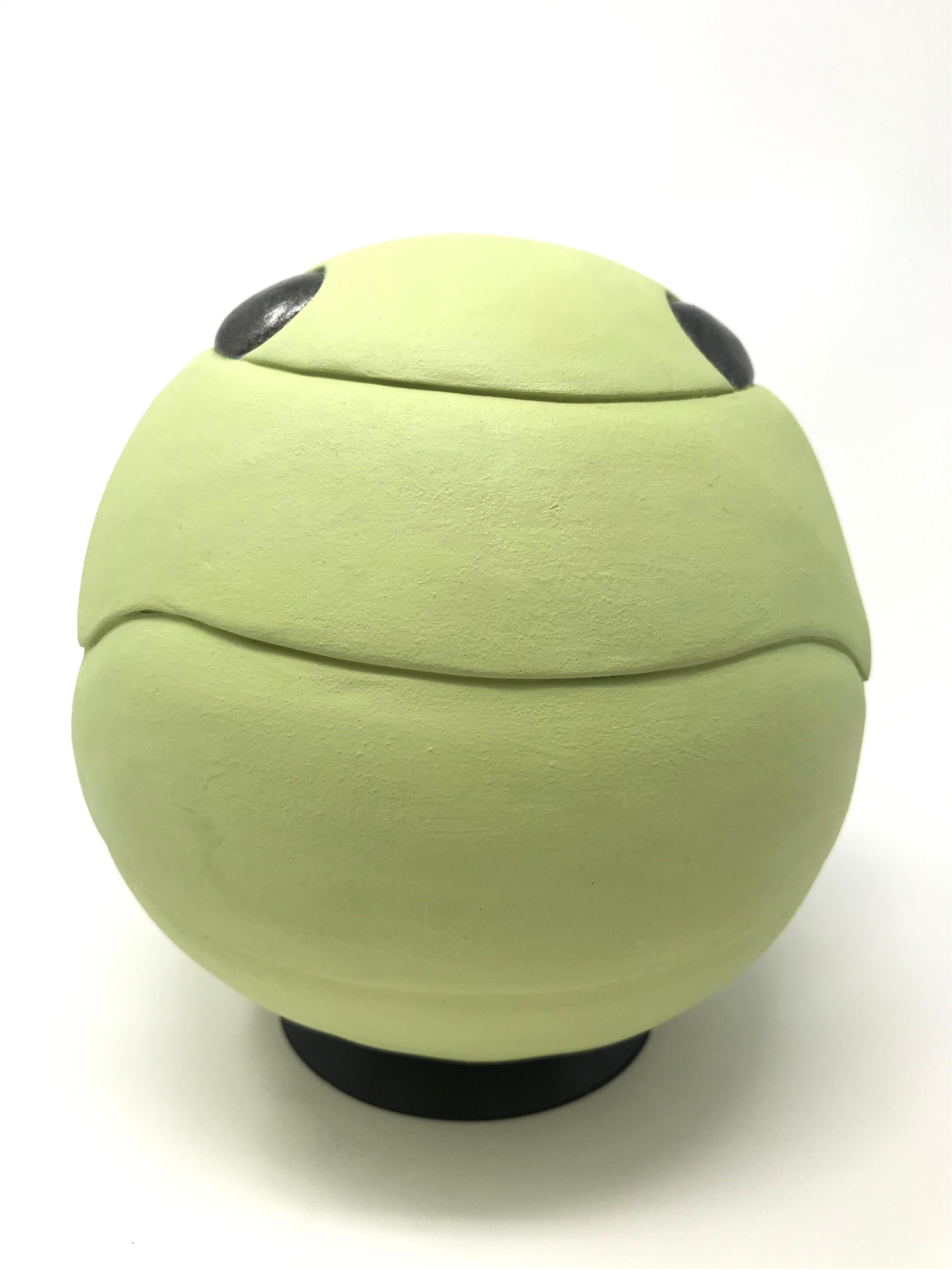 This soft, green, ceramic sculptural depiction of a Roly Poly insect by New York artist Bethany Krull is both playful and sophisticated.  The piece is hand-built, without the use of molds in clay and then fired and finished with soft-matte green and