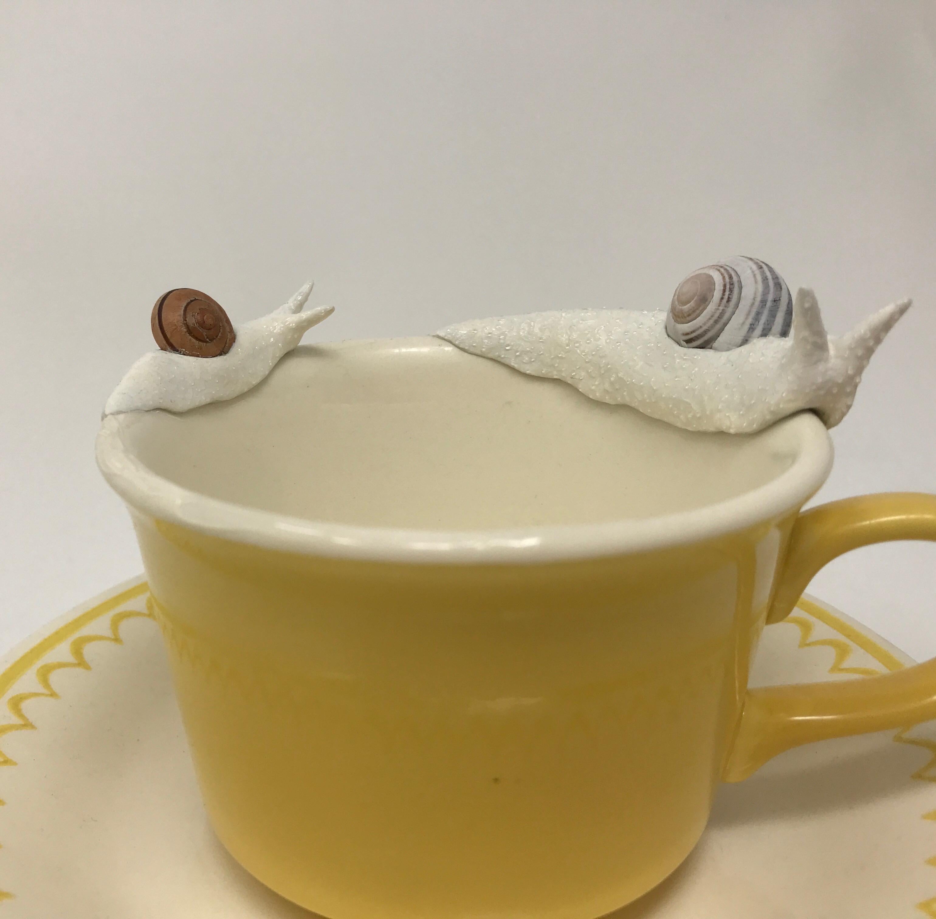 Snails on a yellow mug 