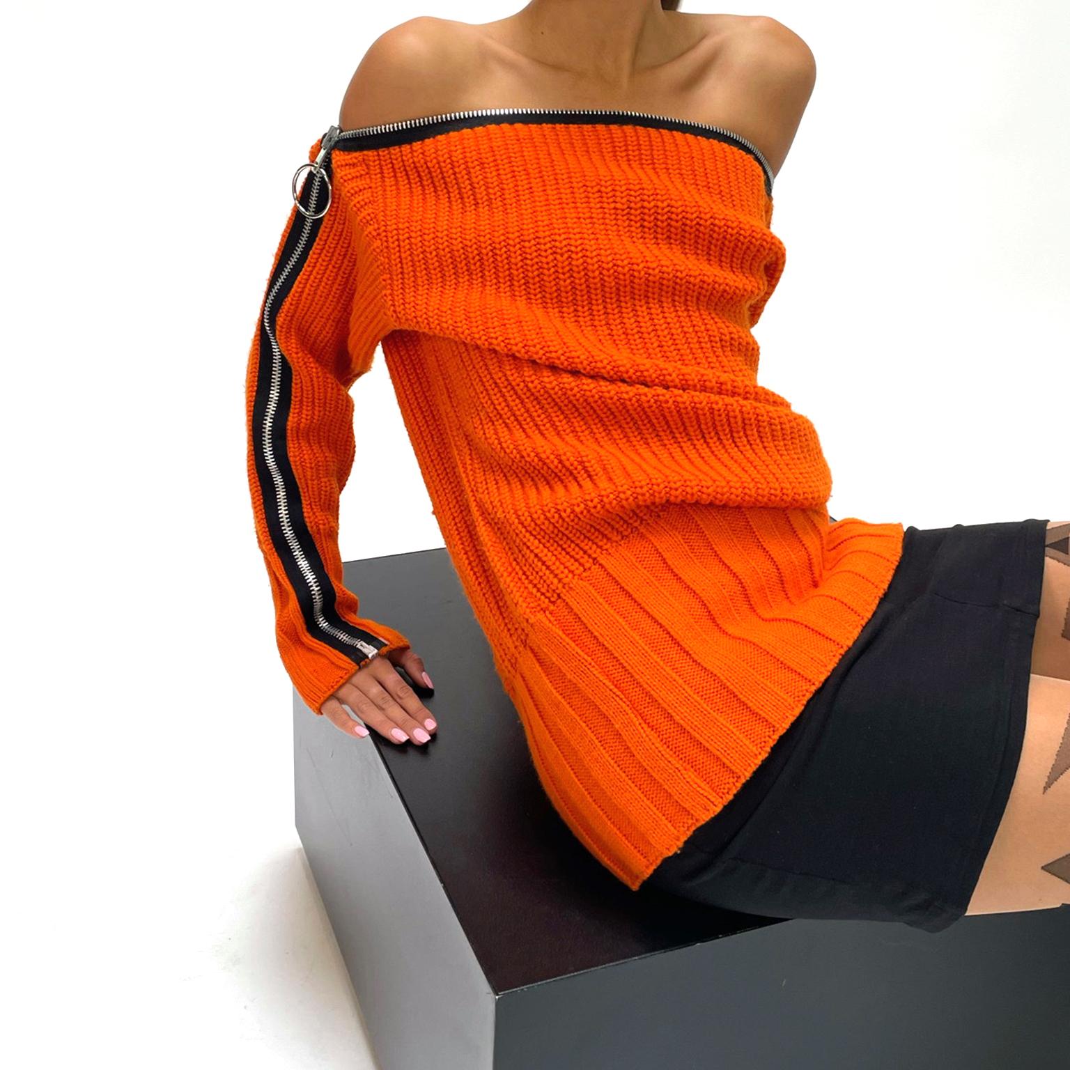 This is a really fun vintage 1980's Betsey Johnson 2 piece outfit with a gorgeous orange chunky knit sweater with a dramatic black zipper and a stretch bodycon tube style black skirt that slips on without closures. The sweater can be worn in a