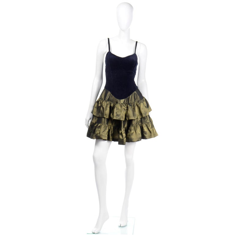 This iconic vintage Betsey Johnson evening dress has all of Betsey's original signature elements. We love the blue velvet bodice that contrasts with an olive green taffeta ruffled skirt. This classic 1980's party dress slips overhead with the ease