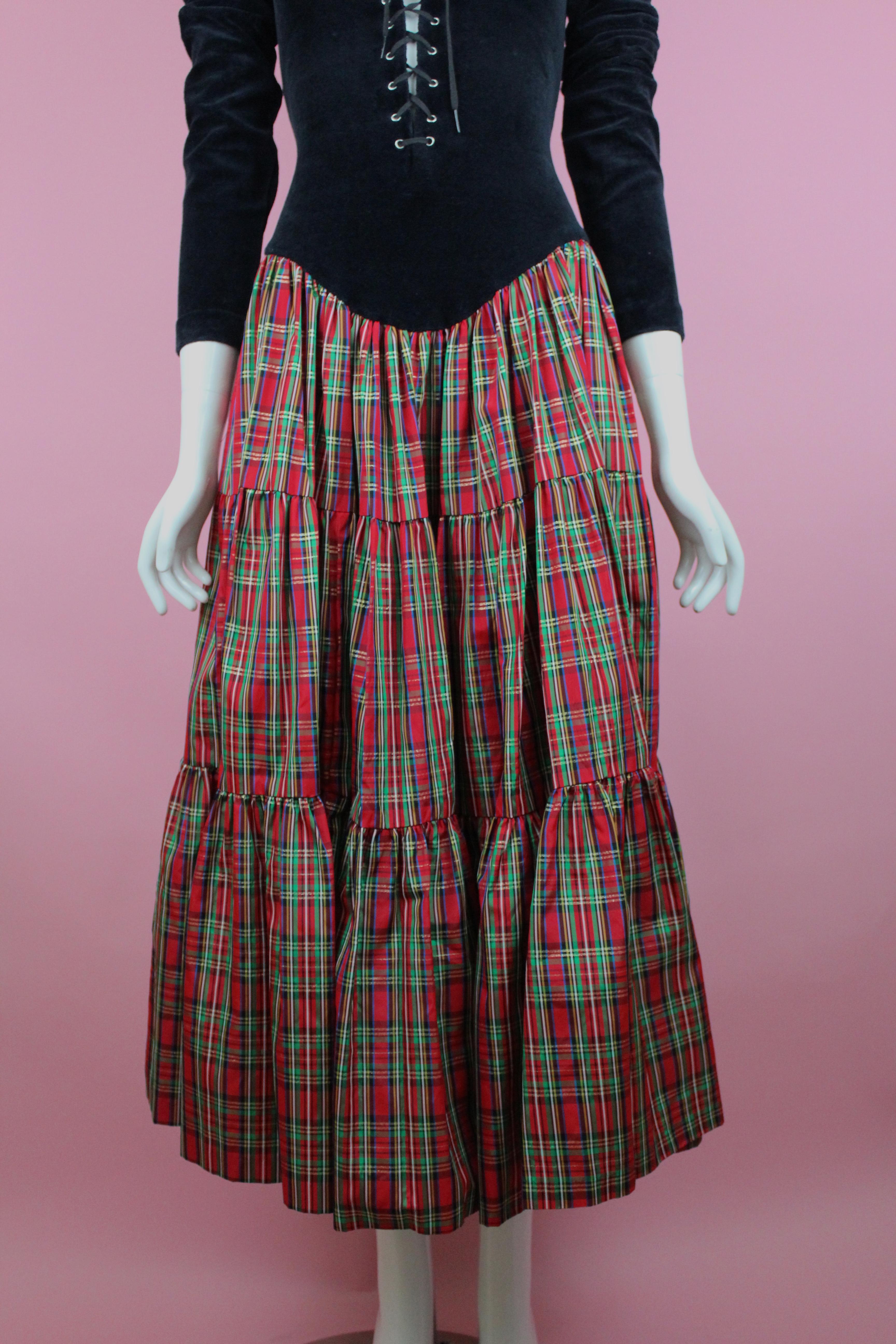 -Betsey Johnson dress with tartan skirt detail, laces at the torso
-Dress reaches to mid-calf 
-Shows 80's label 
-Sized 4-6 
-Made in the USA

Approximate Measurement 
-Total length: 49