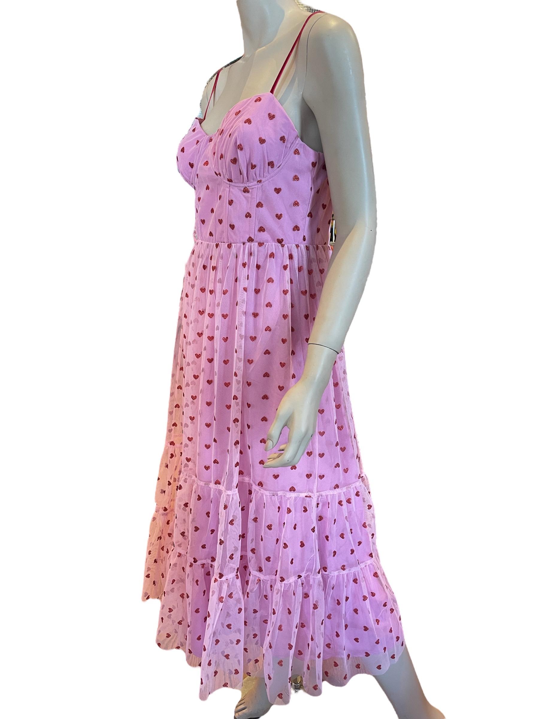 Betsey Johnson Valentines Metallica Heart Print Mesh Dress

Betsey Johnson Valentines Metallica Heart Print Mesh Dress, 
new with tags. Fitted through the chest and waist. Has a tiered skirt, sparkly heart print, and sweetheart neckline. Back zipper