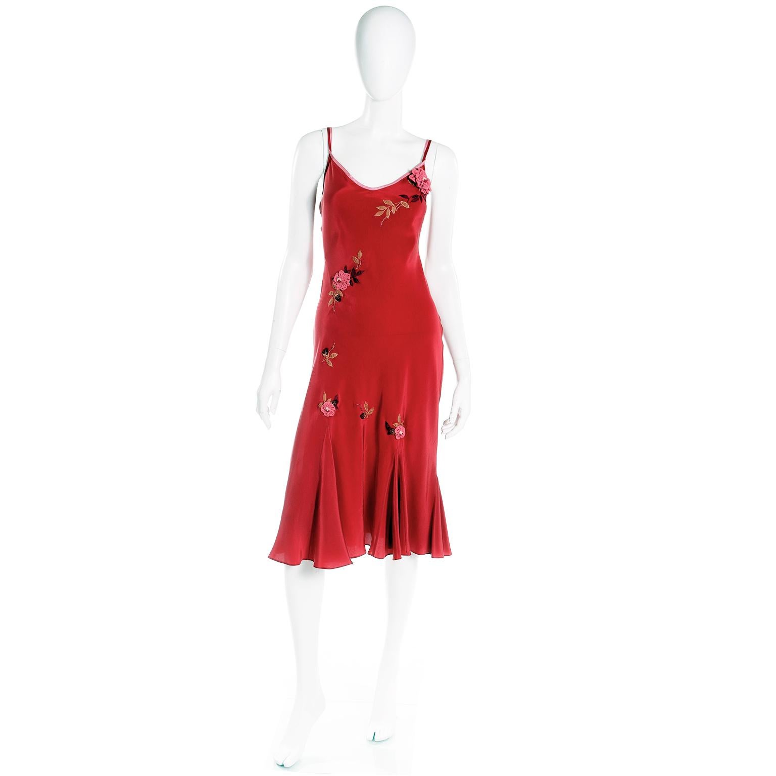 This is a lovely vintage late 1990's or early 2000's Betsey Johnson slip dress in a deep red with pretty pink 3d ruffled flower appliques and embroidered leaves in shades of burgundy and gold. This bias cut evening dress has pink trim at the top and