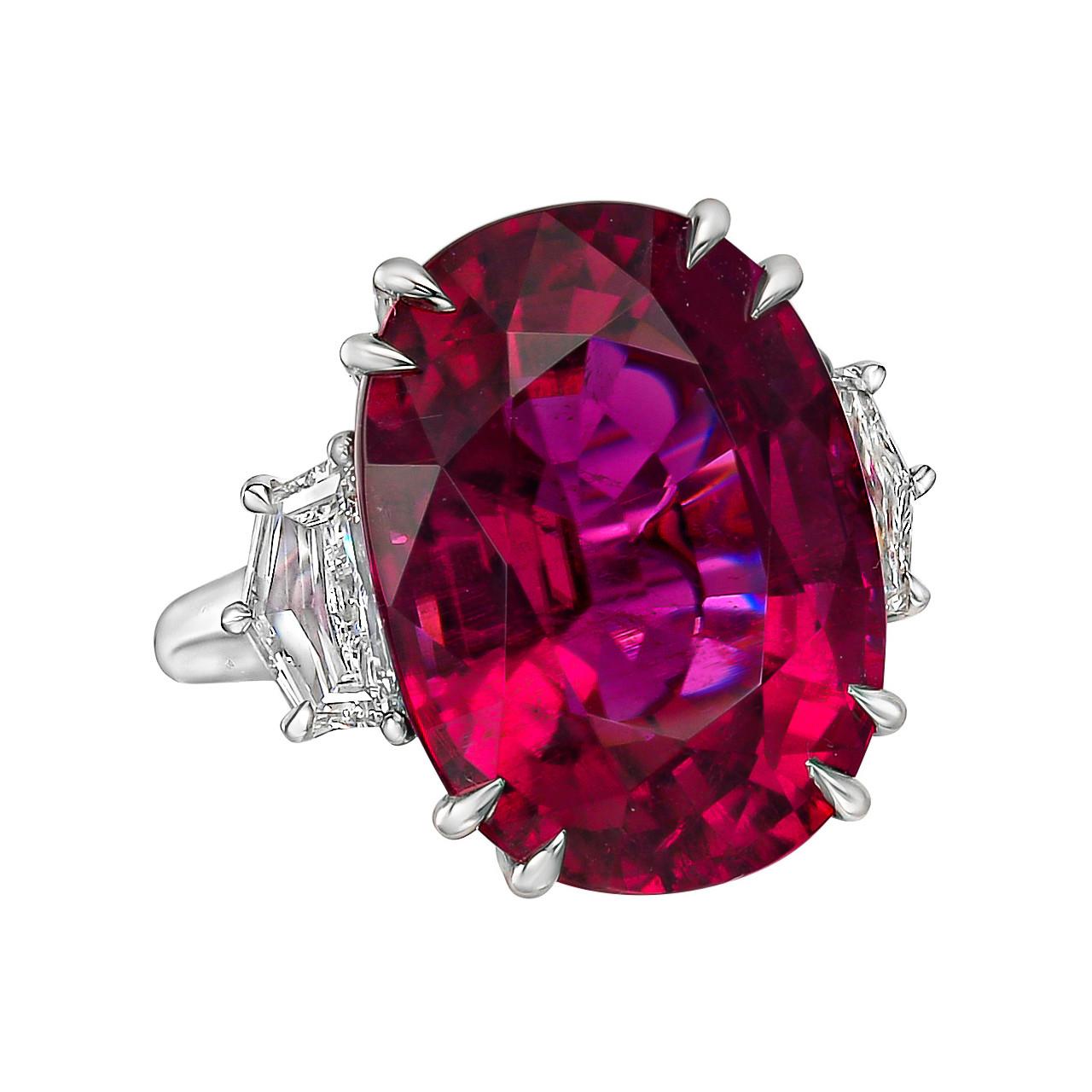 Cocktail ring, centering an oval-shaped pink tourmaline weighing 20.45 carats flanked by trapezoid-cut diamonds, mounted in polished platinum.

Two diamonds weighing 1.37 total carats (F-G color, VS1-VS2 clarity)
