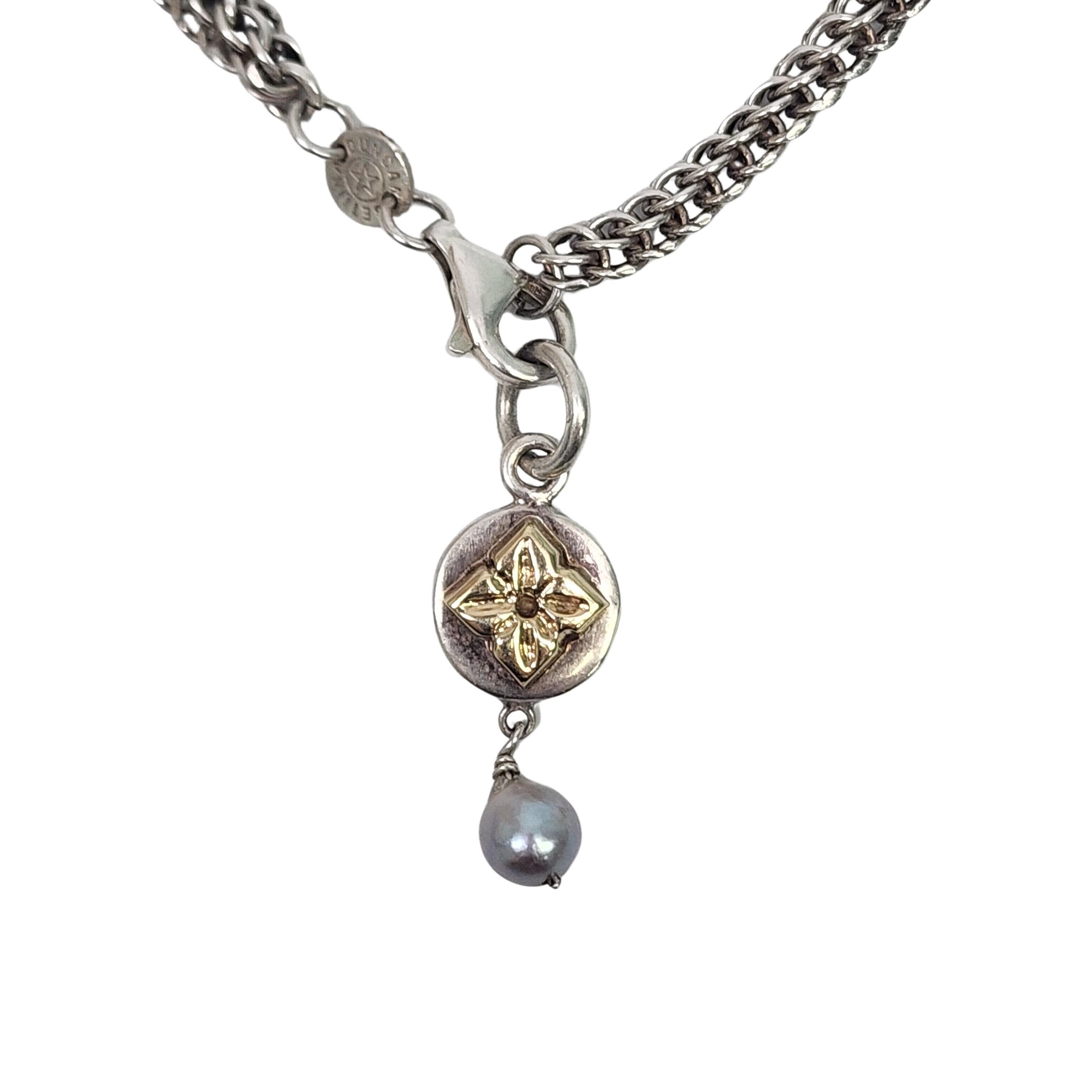 Sterling silver and yellow gold flower pearl pendant wheat chain necklace by Bettina Duncan.

A sterling silver pendant featuring a yellow gold flower and dangling grey pearl hangs from a thick sterling silver wheat chain.

Weighs approx 24.1g,