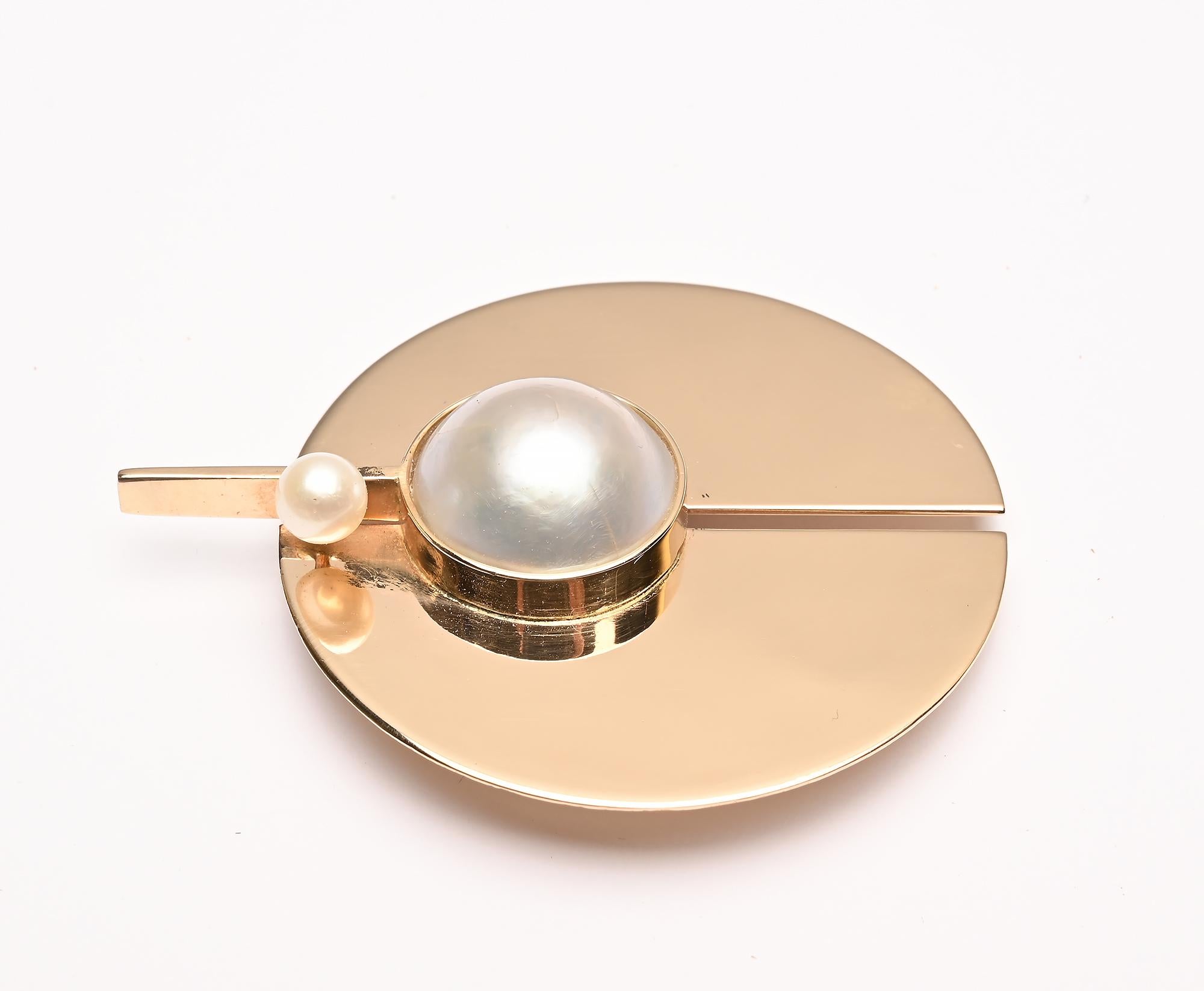 Gold disc brooch by modernist  designer, Betty Cooke. Cooke is considered one of the icons of the Modernist studio jewelry movement. Her work is in the permanent collections of the Museum of Modern Art; Museum of Arts and Design and the Museum of