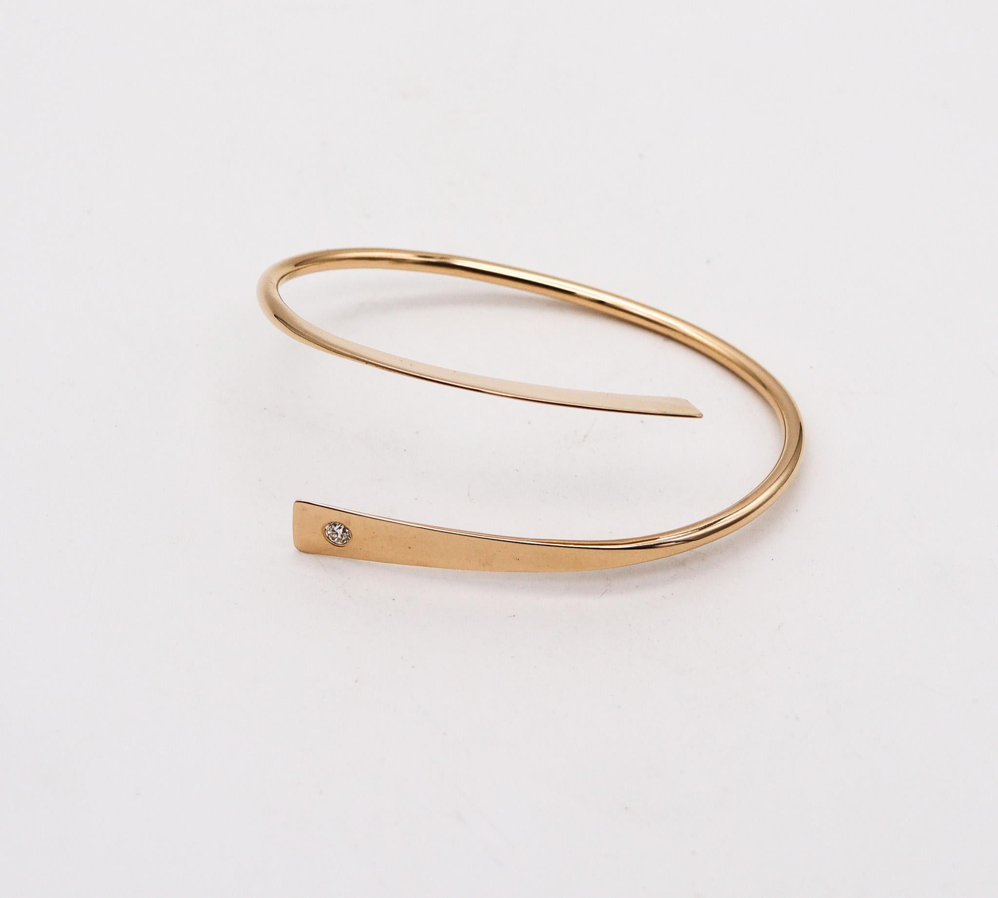 Bangle bracelet designed by Betty Cock.

This is an amazing aerodynamical bangle bracelet, created by the artist-jeweler Betty Cooke. The sculptural bracelet has been crafted as a simple twisted and flattened element, made up in solid yellow gold of