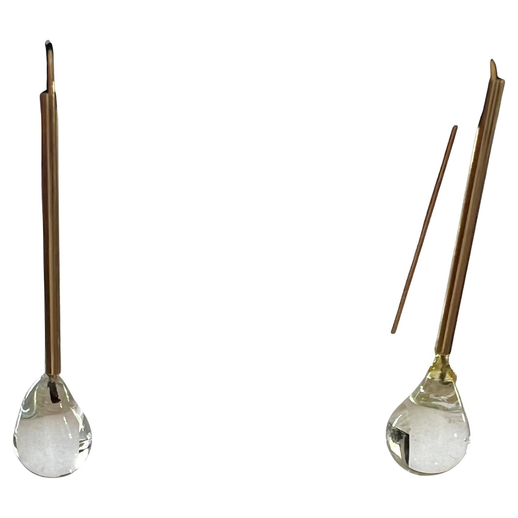 14K gold earrings with crystal drops created by American modernist jeweler, Betty Cooke.  The crystal on one earring has been repaired and is quite stable with a tinge of discoloration.  They measure 2