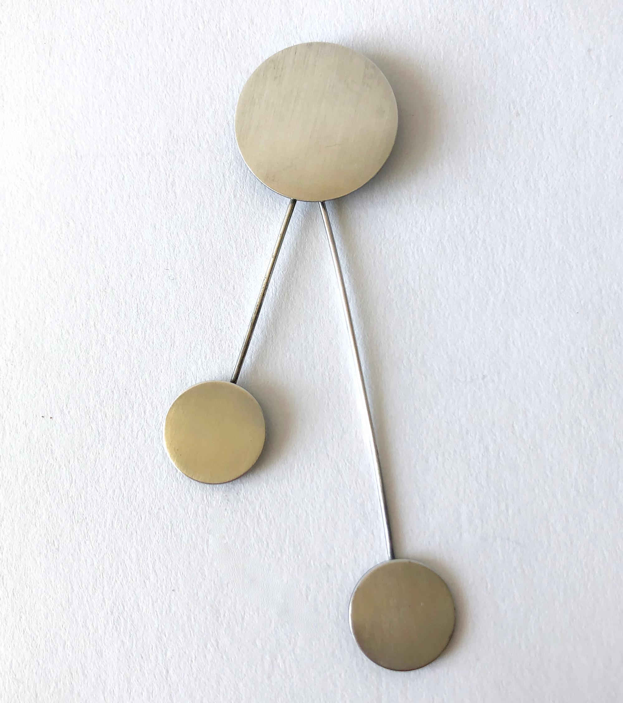Kinetic brushed sterling silver disc brooch created by master silversmith Betty Cooke of Baltimore, Maryland.  Brooch measures 3.75