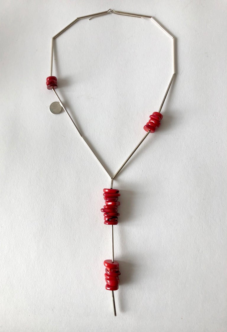 Chinese coral beads on sterling silver tube necklace created by Betty Cooke of Baltimore, Maryland.  Necklace has a wearable neck length of 18