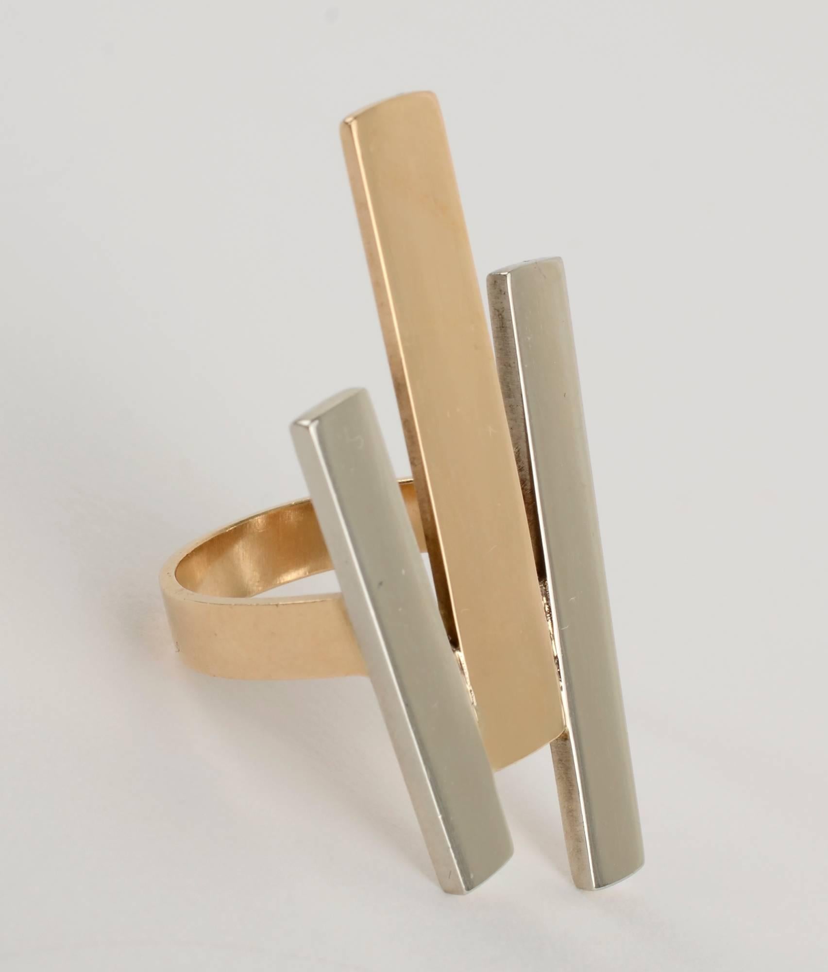 Striking geometric ring by modernist designer, Betty Cooke. Cooke placed one gold rectangle between two of sterling. Each is a different size. The gold rectangle measures 1 3/16