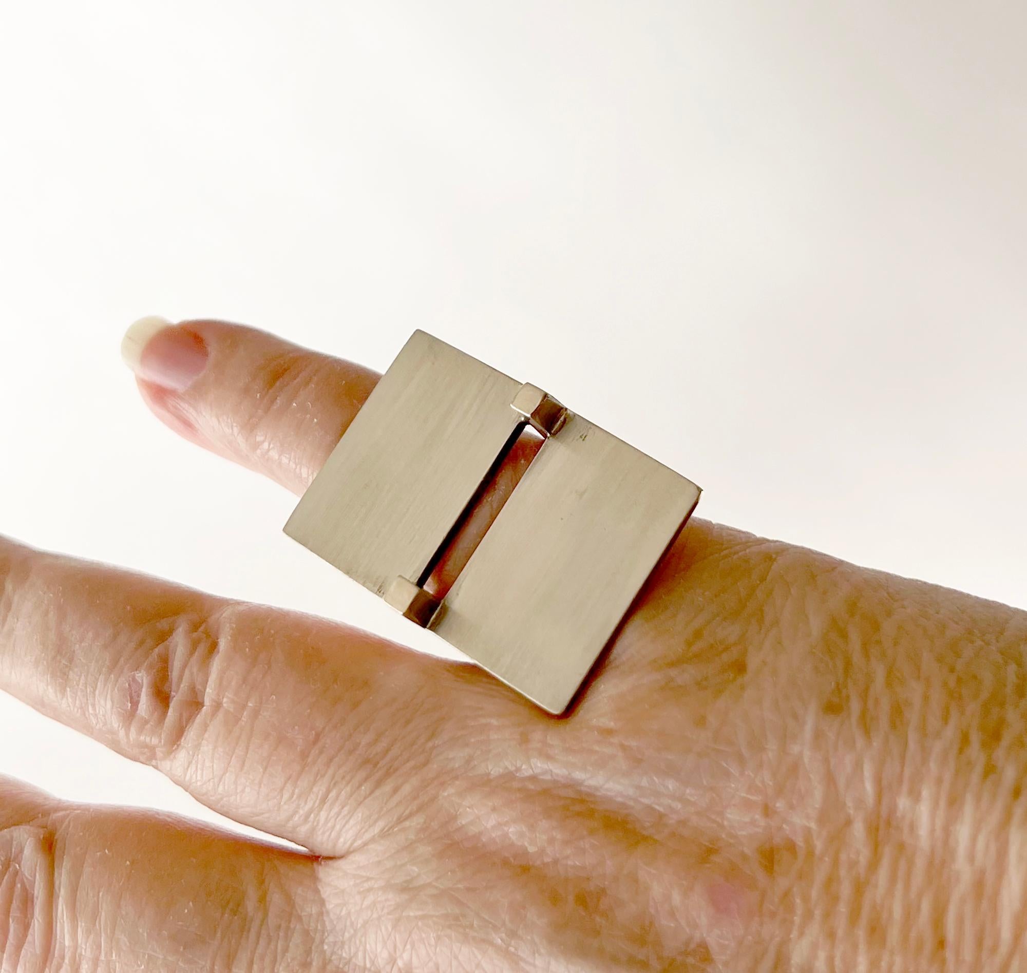 Sterling silver minimalist ring created by Betty Cooke of Baltimore, Maryland.  Hard to measure its size due to the U shaped shank, approximately a size 6.5. Signed Cooke, Sterling.  In very good vintage condition. 