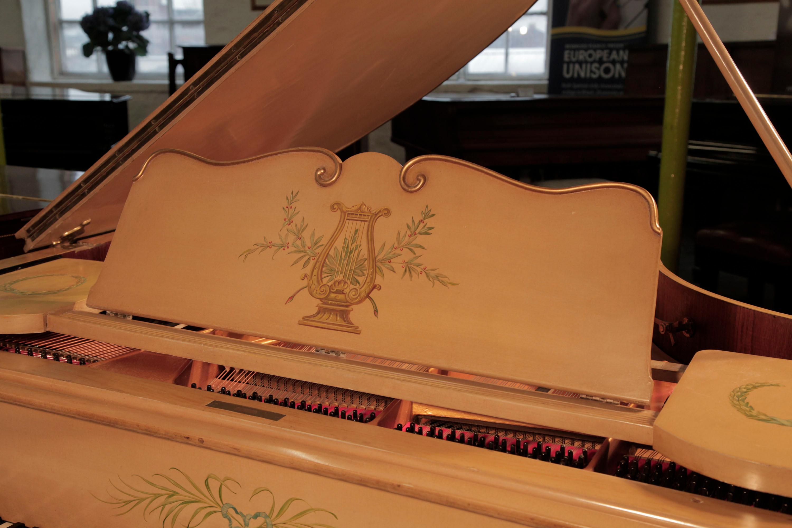 Beuloff baby grand piano with a cream case. Entire cabinet hand-painted with Classical style motifs. It is signed on the cabinet by Jade 85 Wigmore Street.
The cabriole legs with a scalloped top, are hand-painted with flowers and foliage and gilt