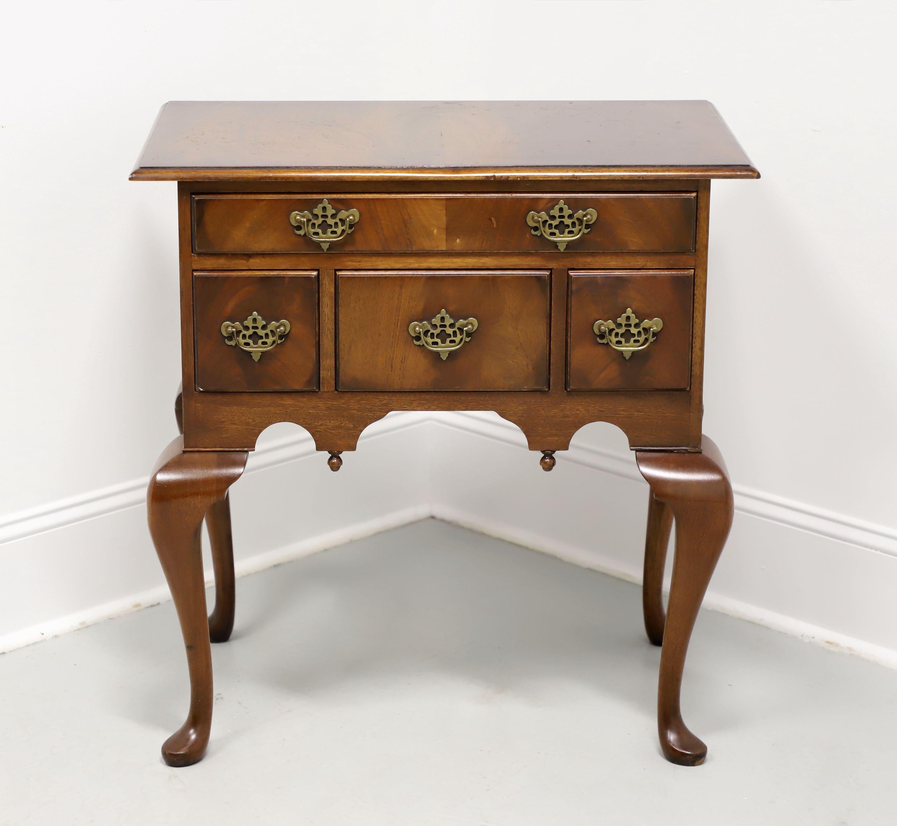 A Queen Anne style entry console table by Bevan Funnell. Mahogany with flame mahogany to top & drawer fronts, finished on all sides, brass hardware, bevel edge to the top, carved apron with downward finials, cabriole legs, and pad feet. Features one