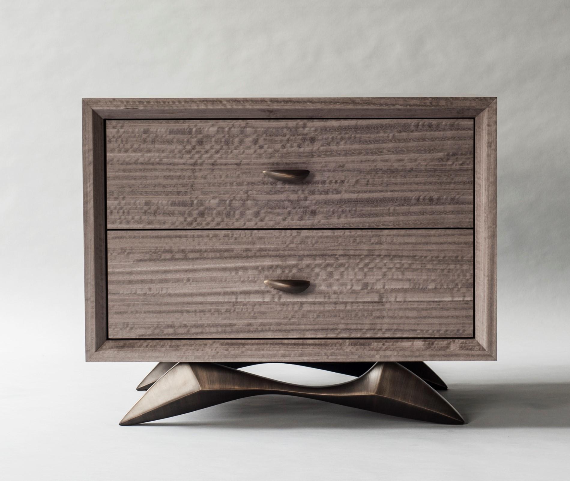 Bevel bedside table by DeMuro Das 
Dimensions: W 75 x D 50.7 x H 61 cm
Materials: Eucalyptus (Slate) - Matte
 Solid Bronze (Antique) handles and legs

Dimensions and finishes can be customized.

DeMuro Das is an international design firm and