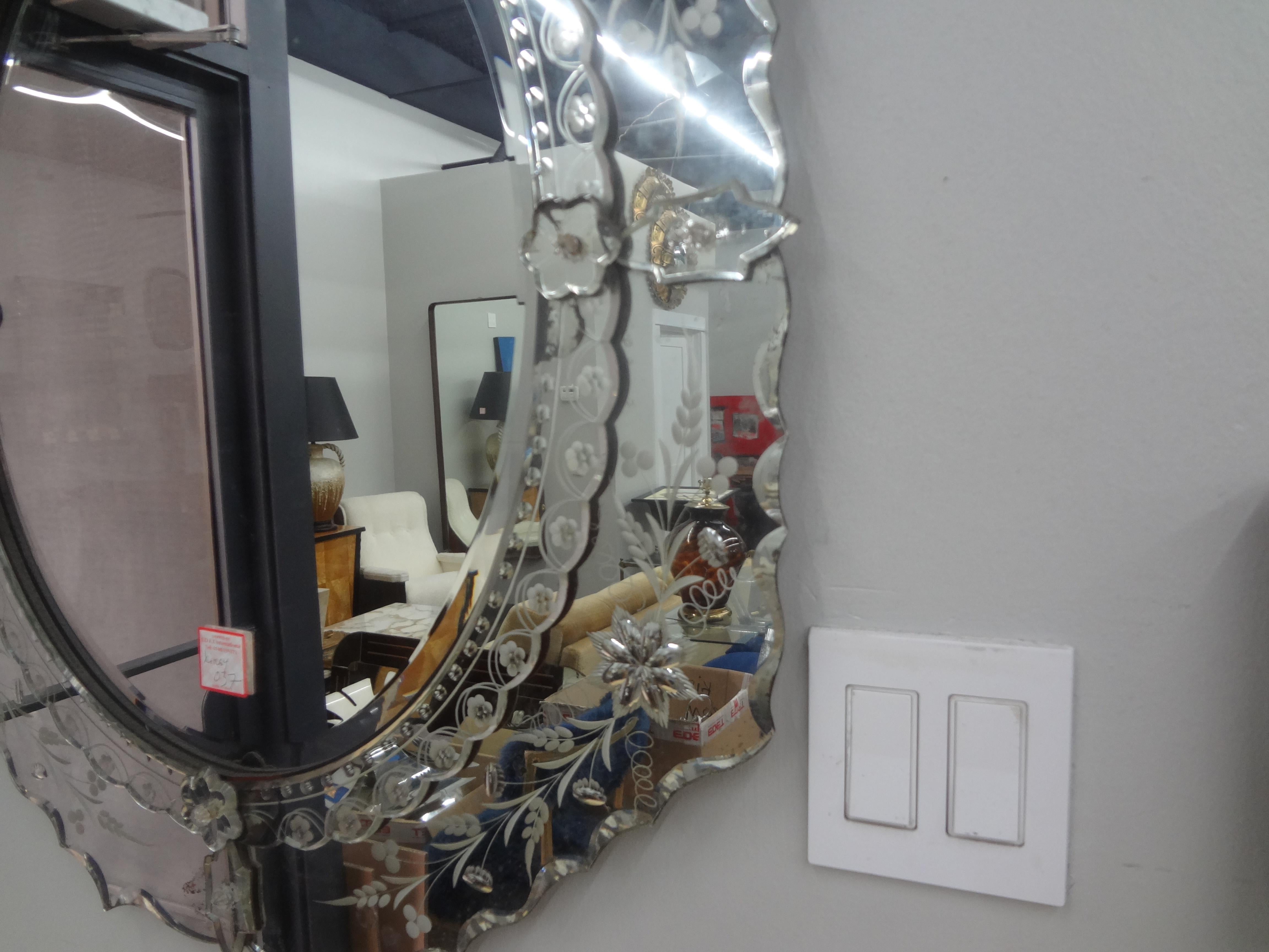 Beveled and etched Venetian mirror.
This elegant unusually shaped Venetian mirror has a lovely etched design with a beveled central mirror that dates to the 1920s.